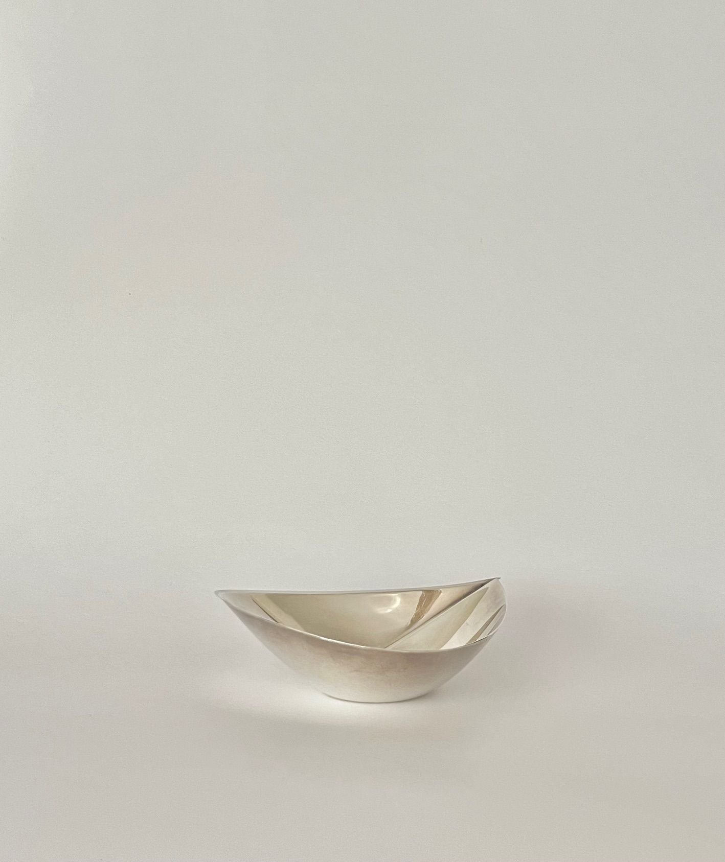 Tapio Wirkkala Silver Bowl 1957 — side angle on neutral background