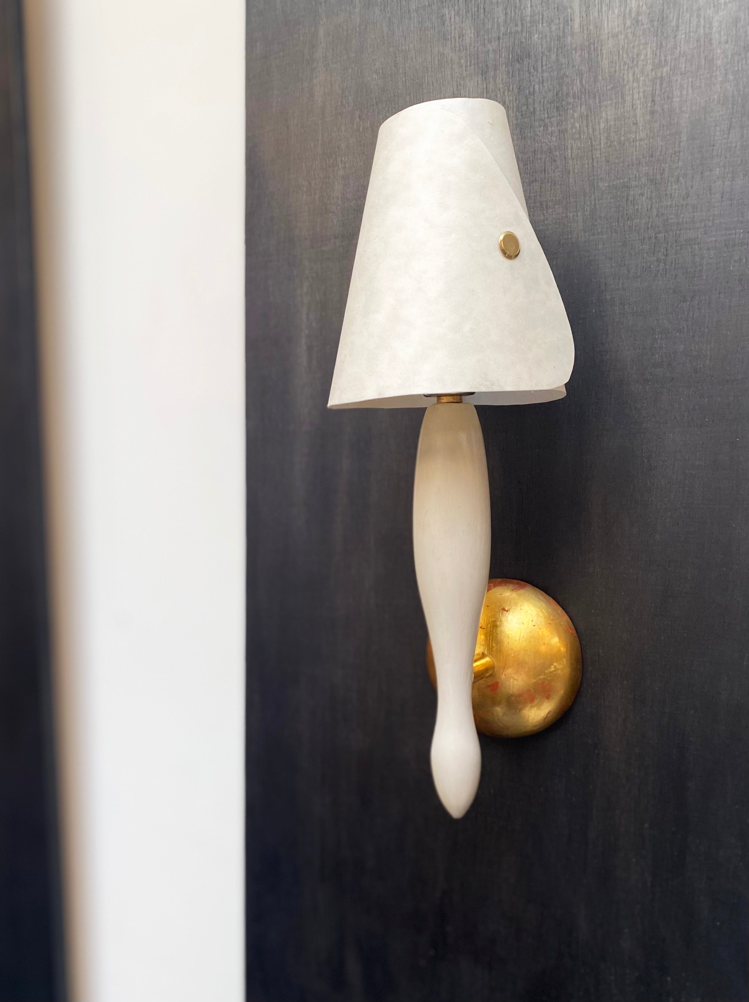 CALYX WALL LIGHT D;1992 RELAUNCHED 2024 — mounted on dark wall with brass base