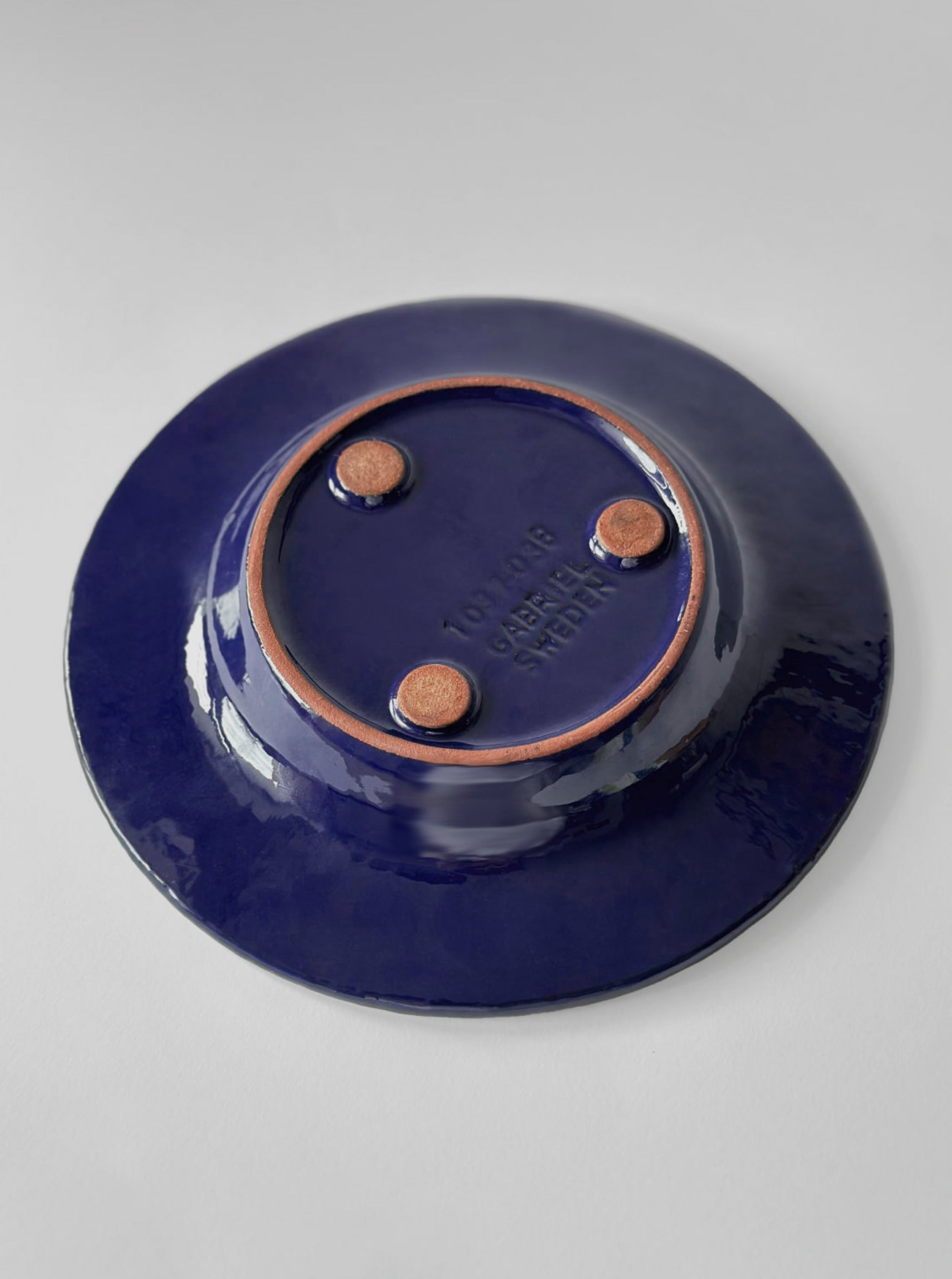 Ingegärd Burmeister Decorative Ceramic Plate — underside view with navy glaze finish