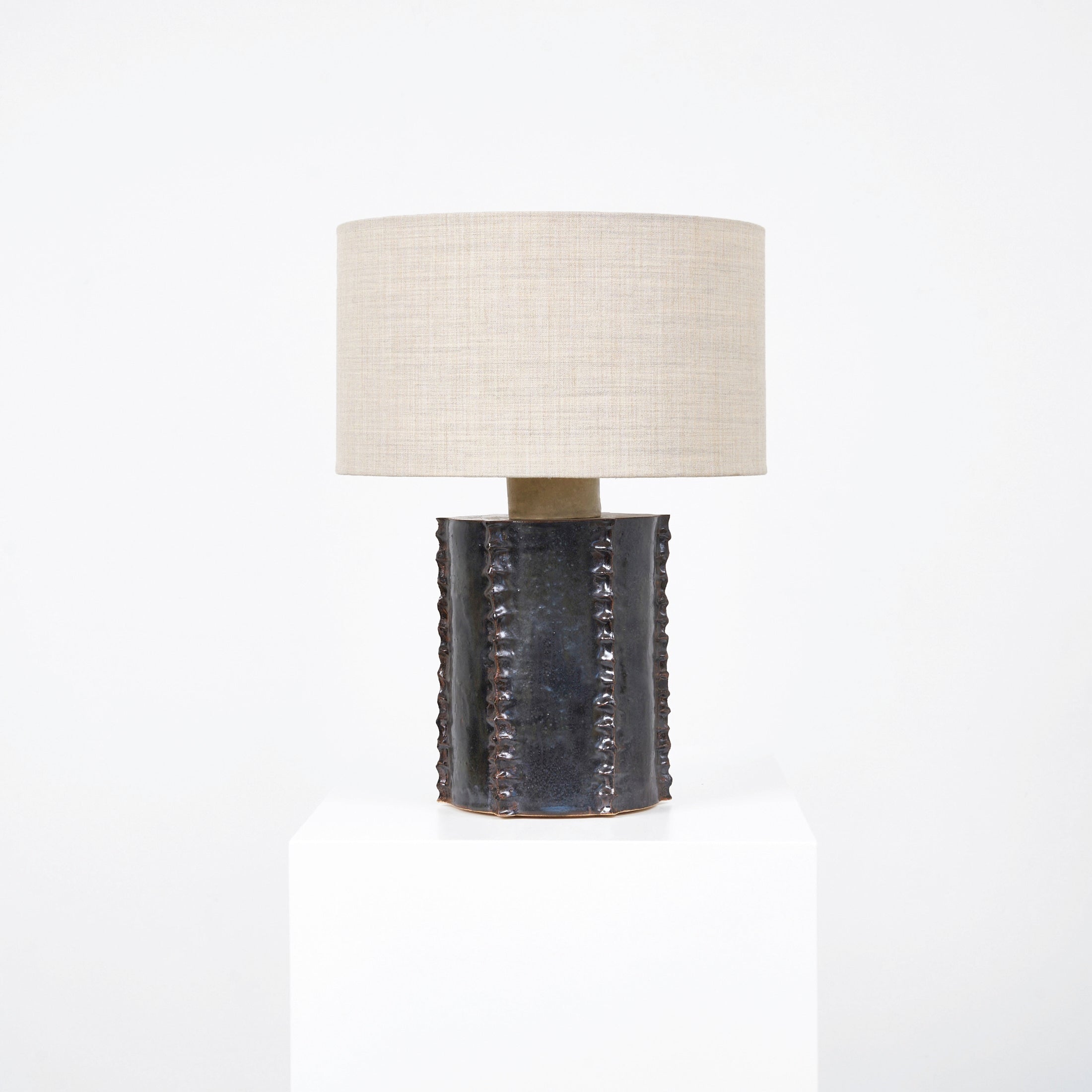 Totem Table Light — front view on white pedestal with linen shade