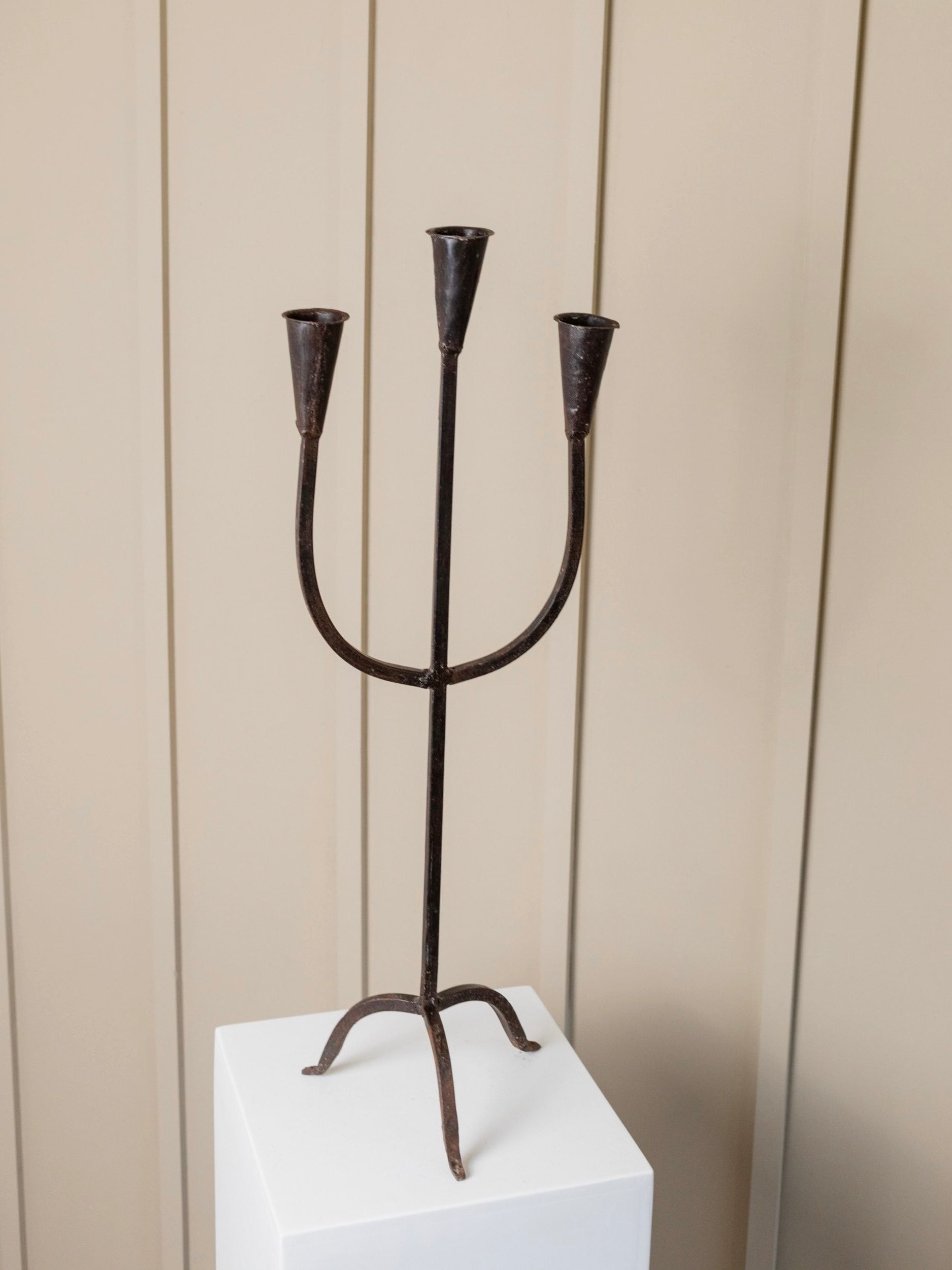 XXL Brutalist metal Candle Holder Italy 1960s — side angle on white pedestal
