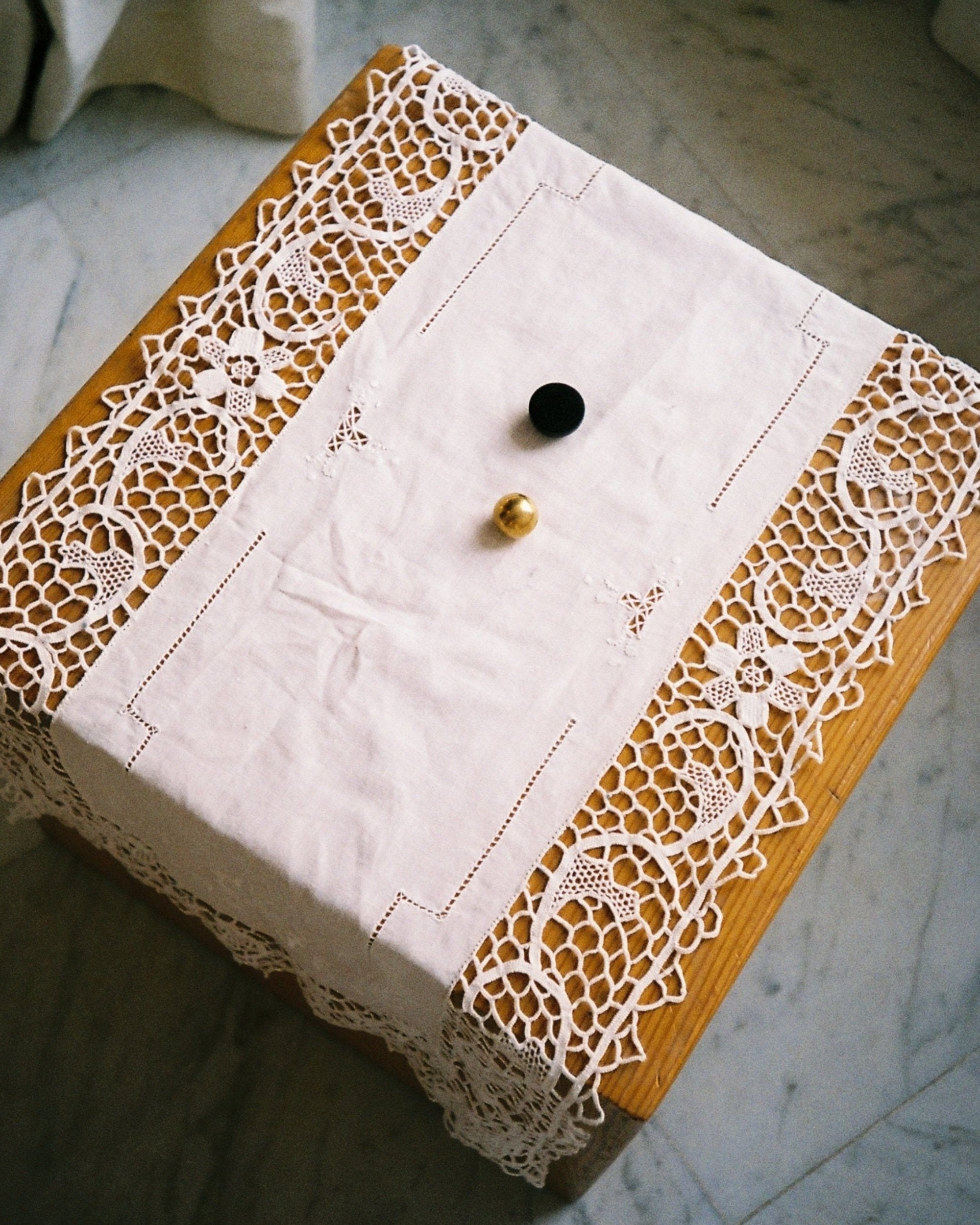 CERCLE Cabinet Knob Small — overhead view on lace tablecloth