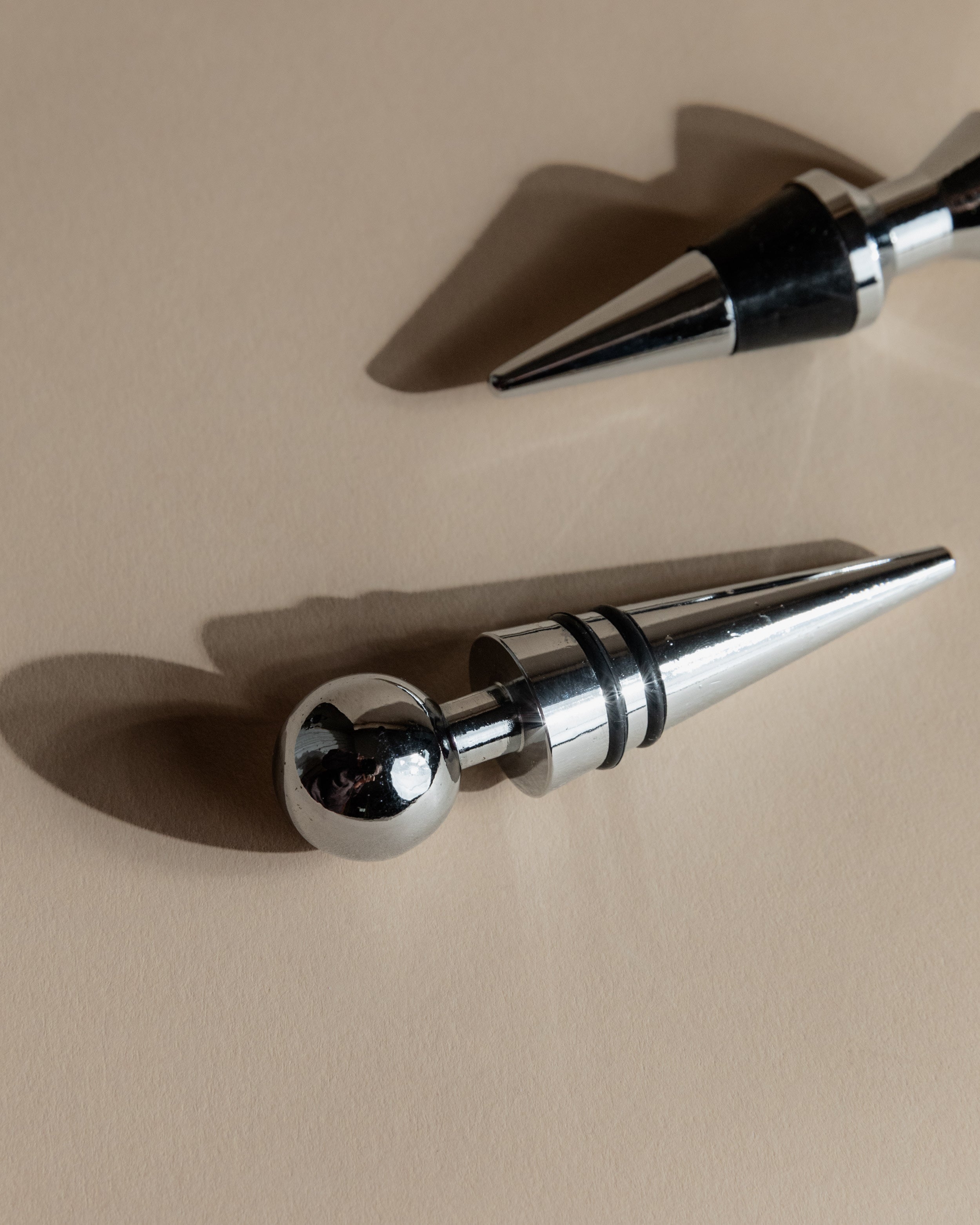 Vintage 1980s Bottle Stoppers Set of 2, Metal Geometric Conical Design Italy — back view highlighting polished chrome finish