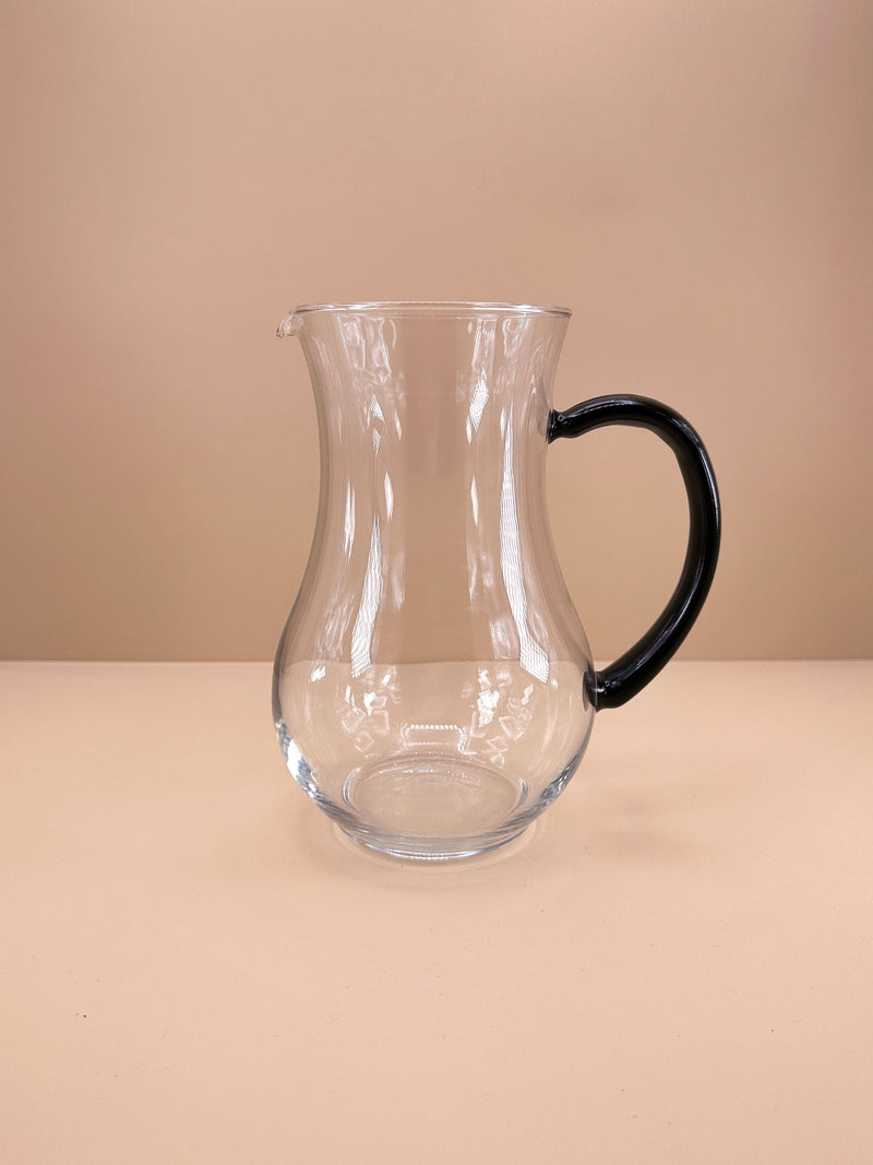 1980s Art Deco Revival carafe — close-up of clear glass with black handle