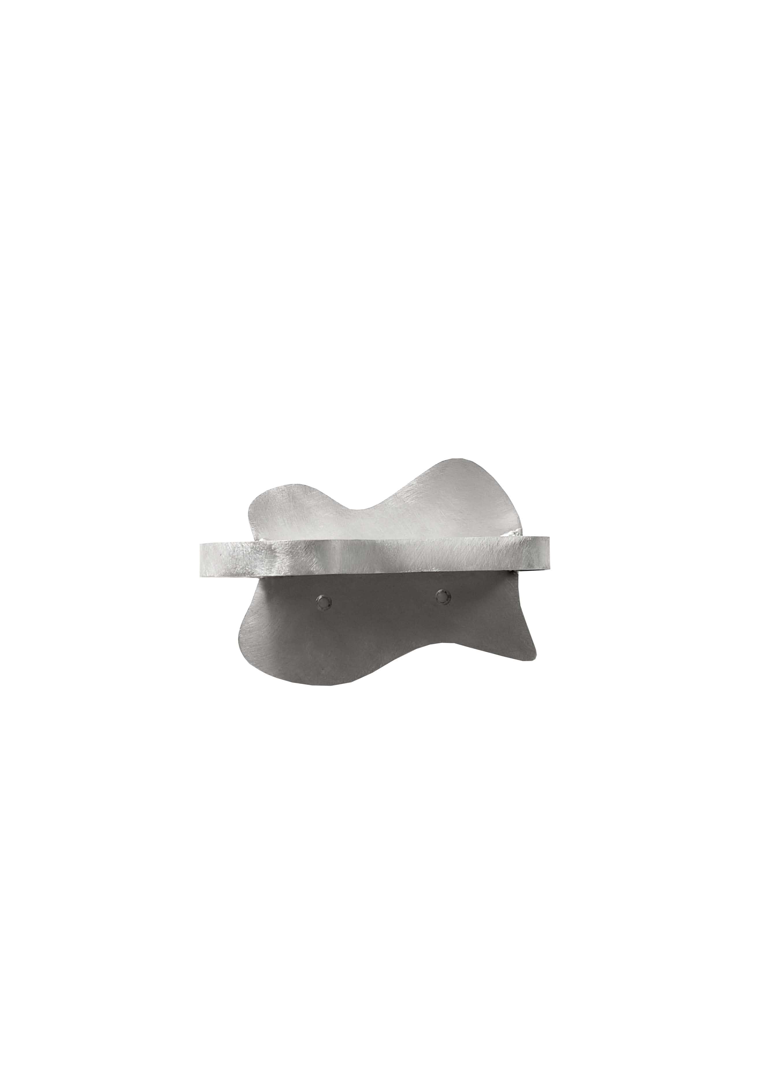 Small Shelf — front view of textured metal surface