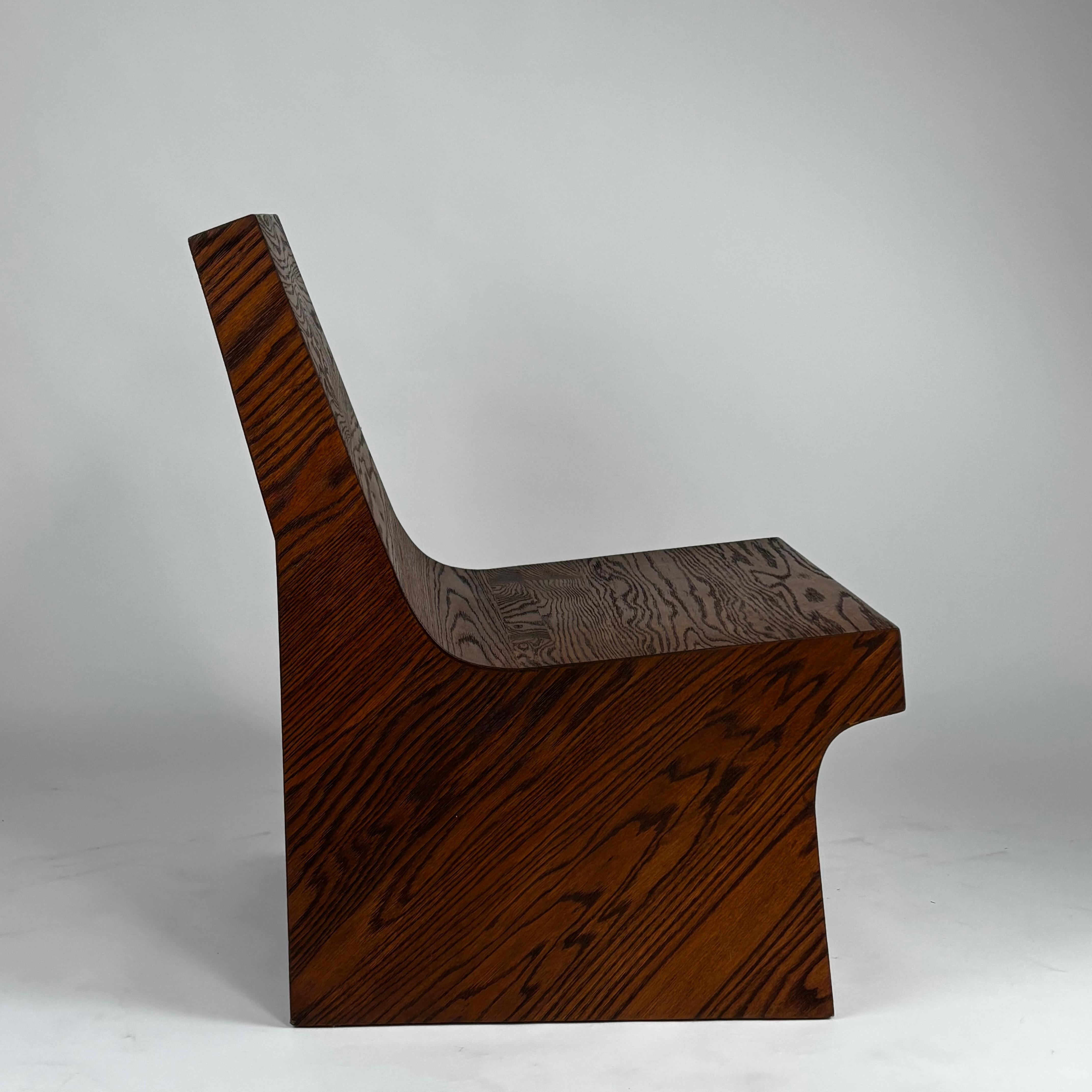 Pair of NONO Lounge Chairs by Joel Escalona — side angle showing dark wood grain