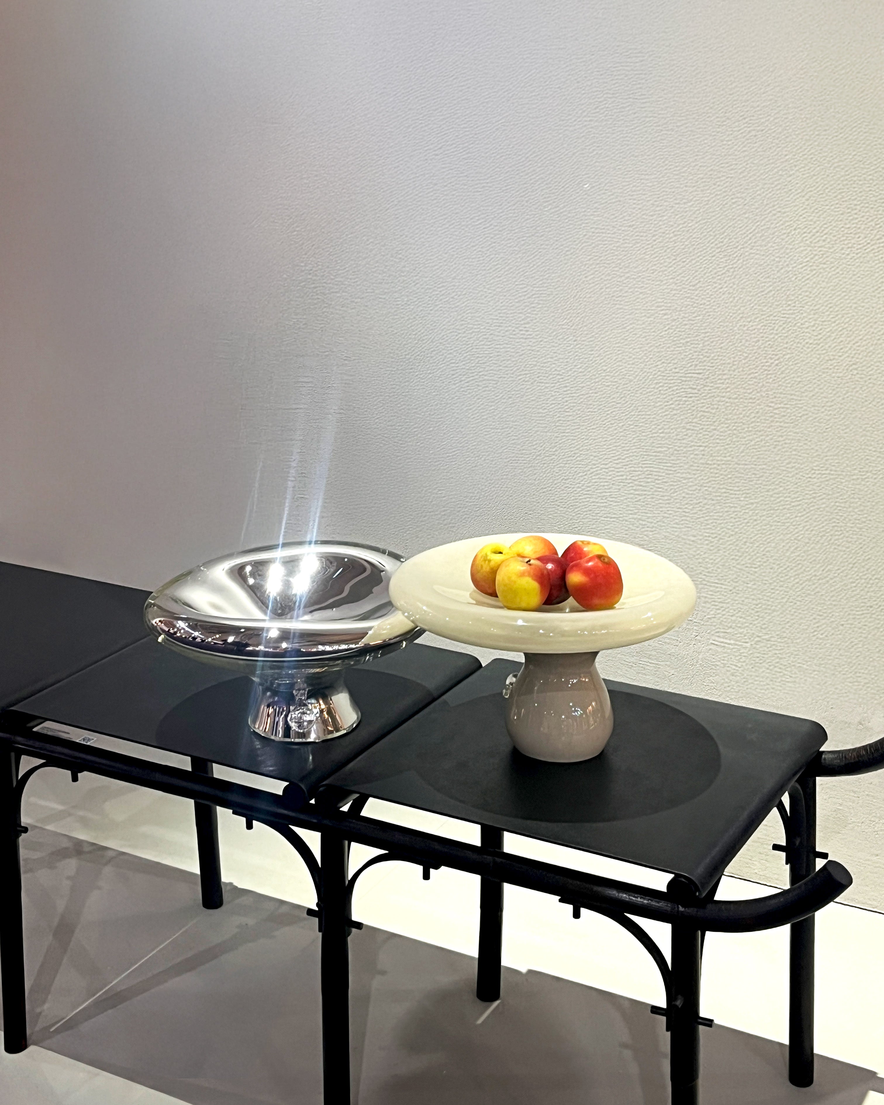 Sylve Mirror Plate — polished metal bowl on black bench