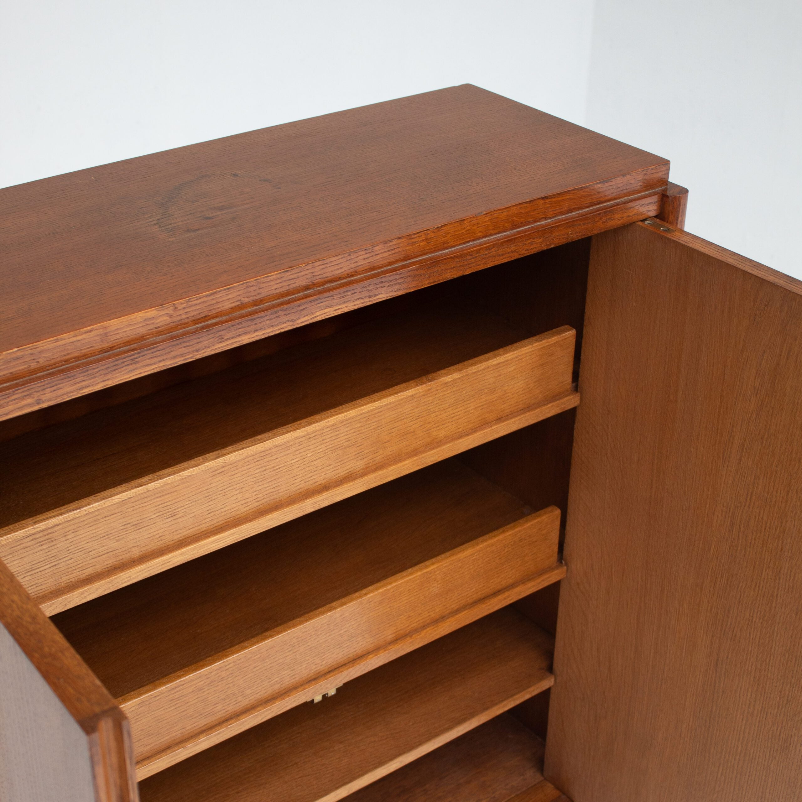 Mid-Century Oak Cabinet with Brass Handles and Decorative Inlays — side angle