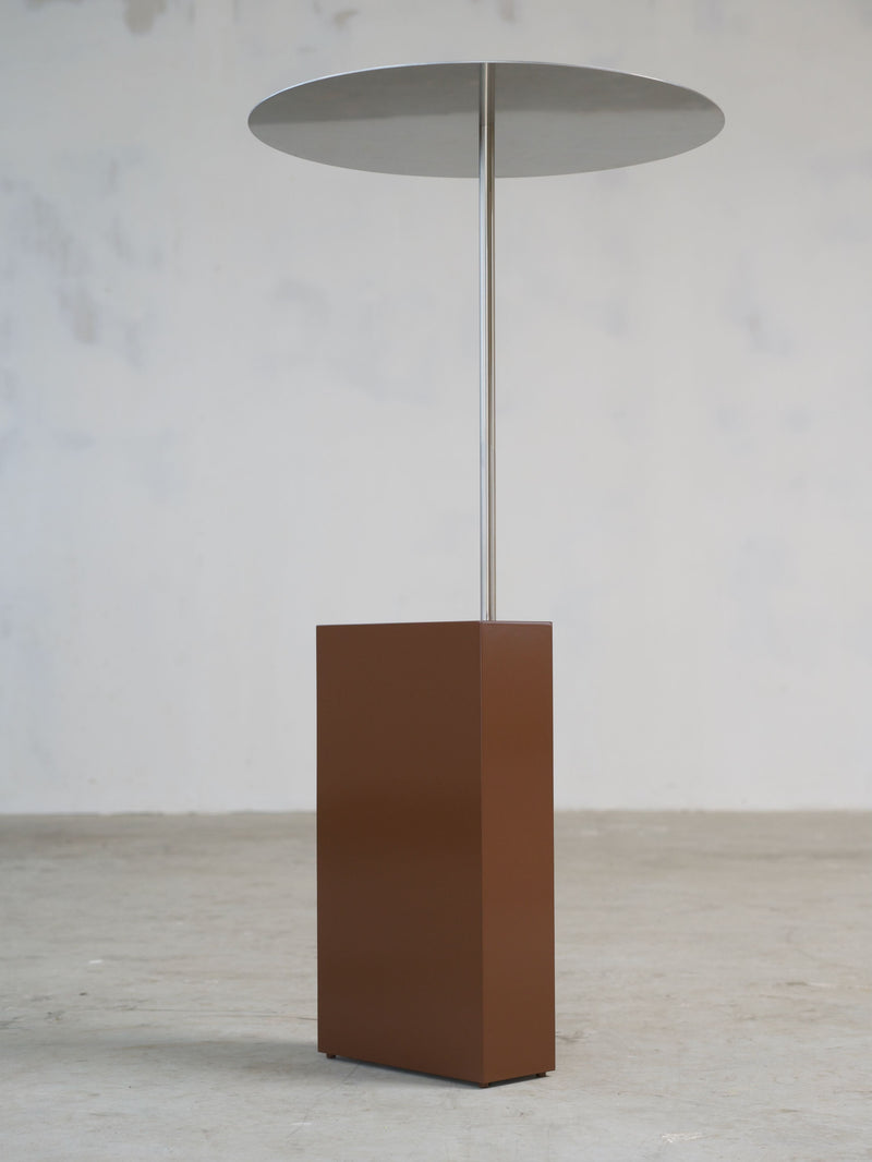 The Assistant' Side Table — close-up of brown metal base and round top