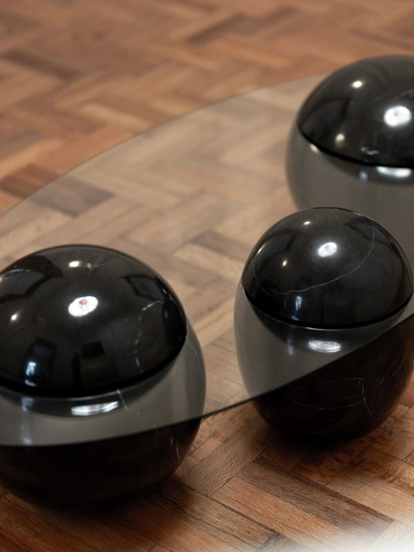 Ovni Uovo' Coffee Table — top view of black marble spheres on glass