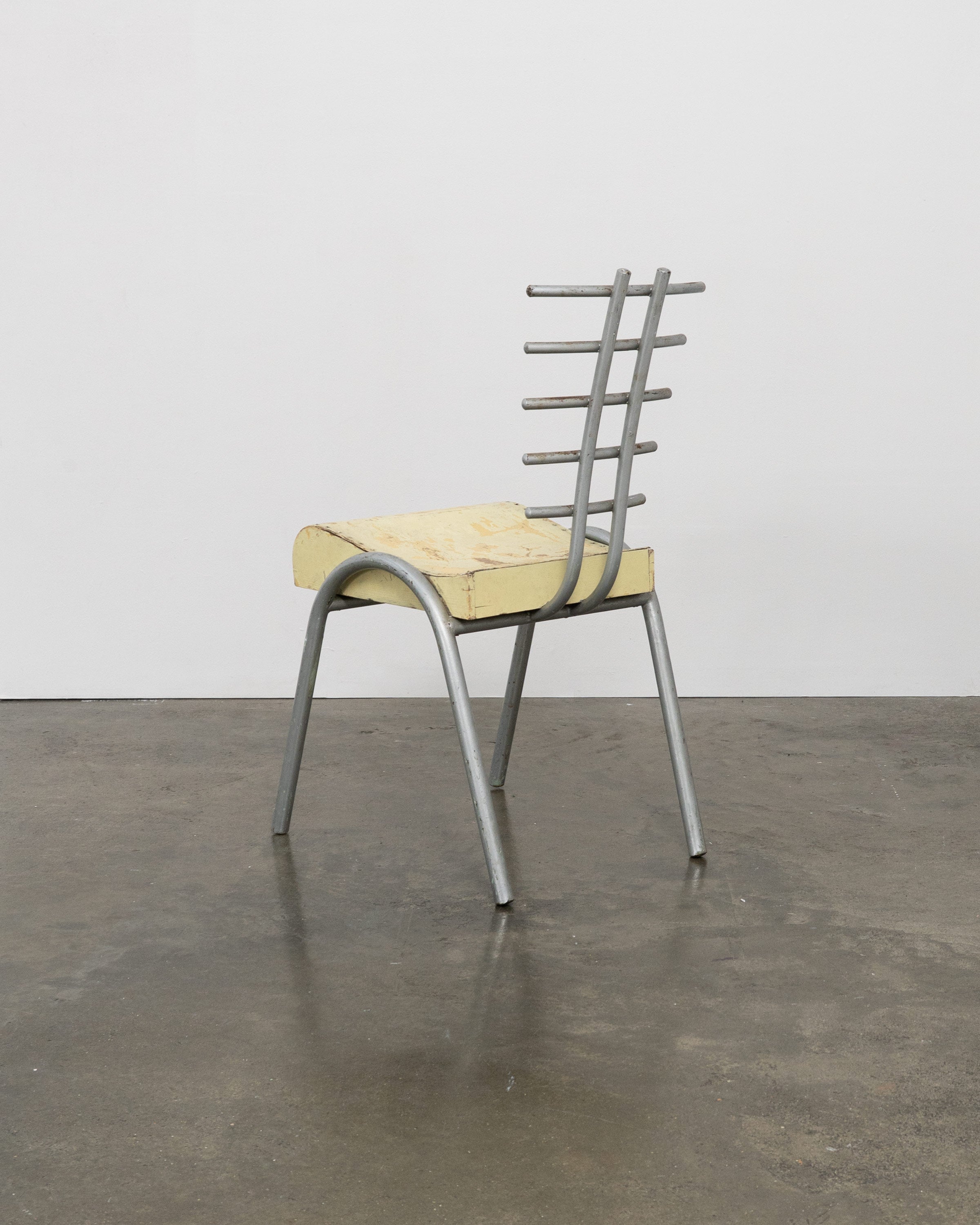 Postmodern prototype chair with ladder-back design and yellow seat