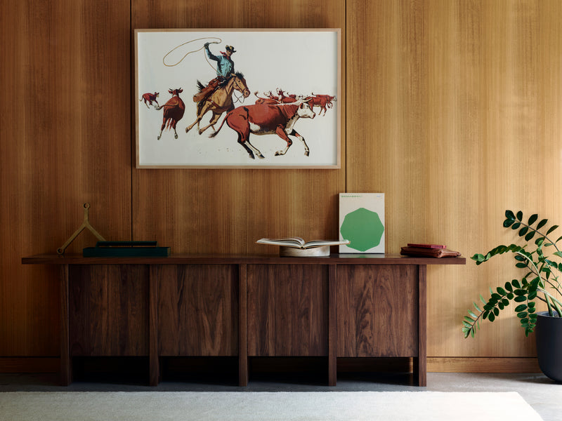 Edda Credenza — close-up of walnut wood surface with artwork above