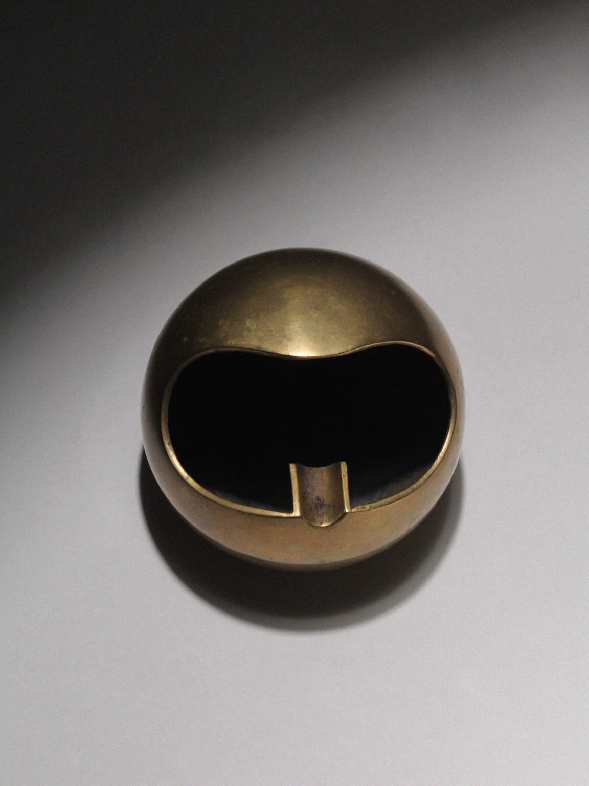 Modernist Spherical Brass Ashtray — detail view