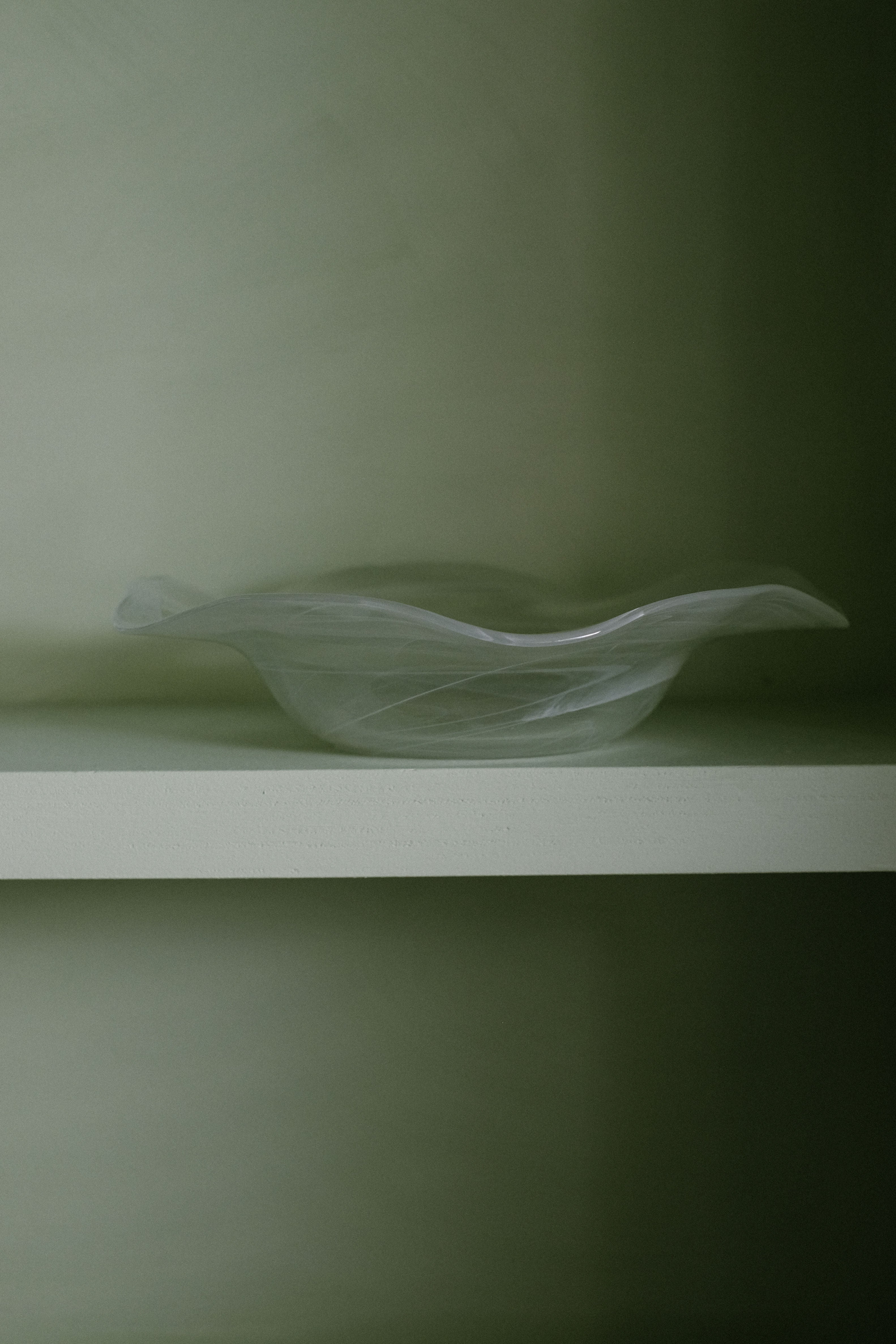 Swirl Glass Bowl — top view on light green shelf