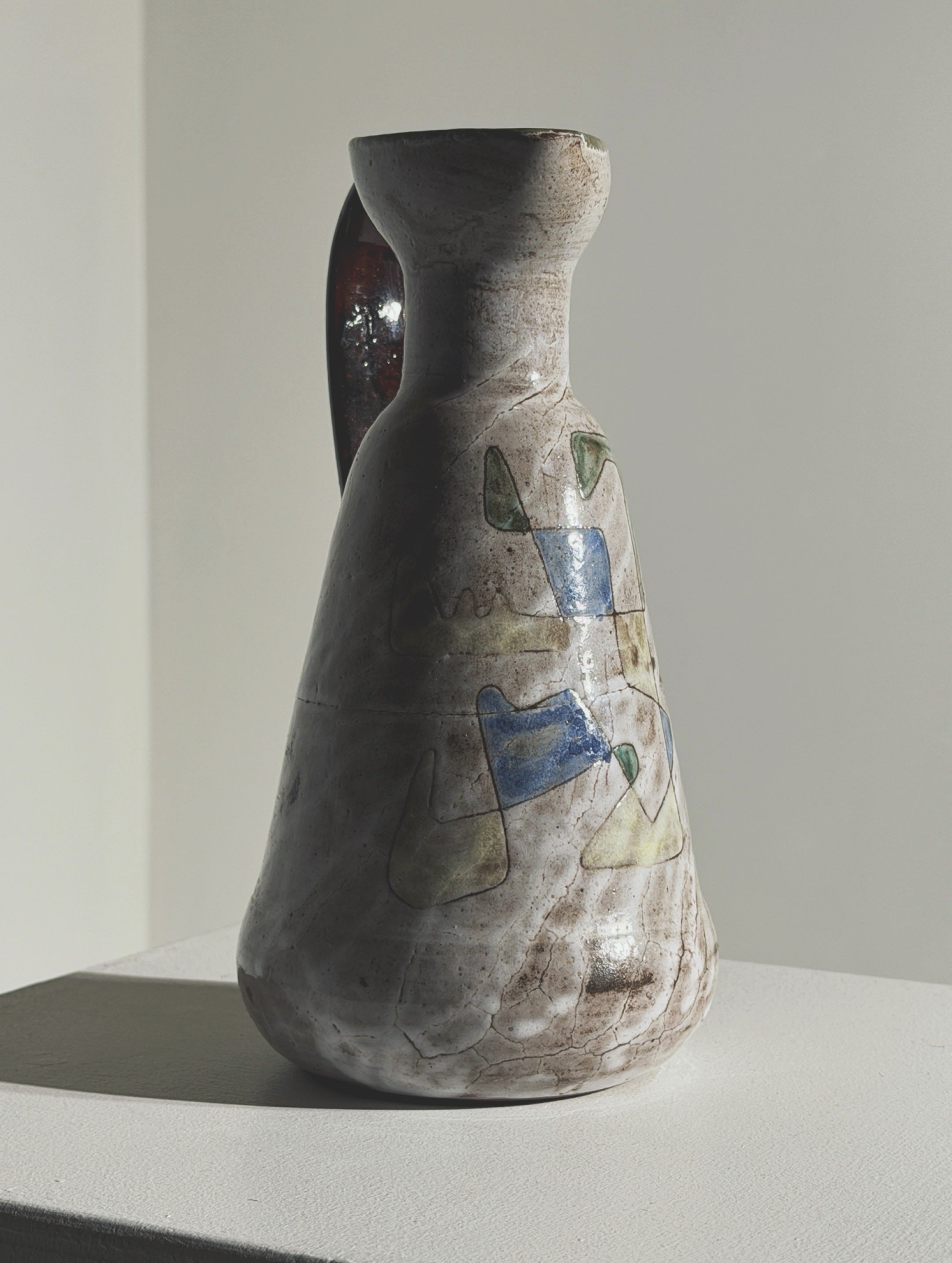 Ceramic pitcher by Jean Rivier, Vallauris, circa 1960 — side angle showing earthy tones and decorative patterns