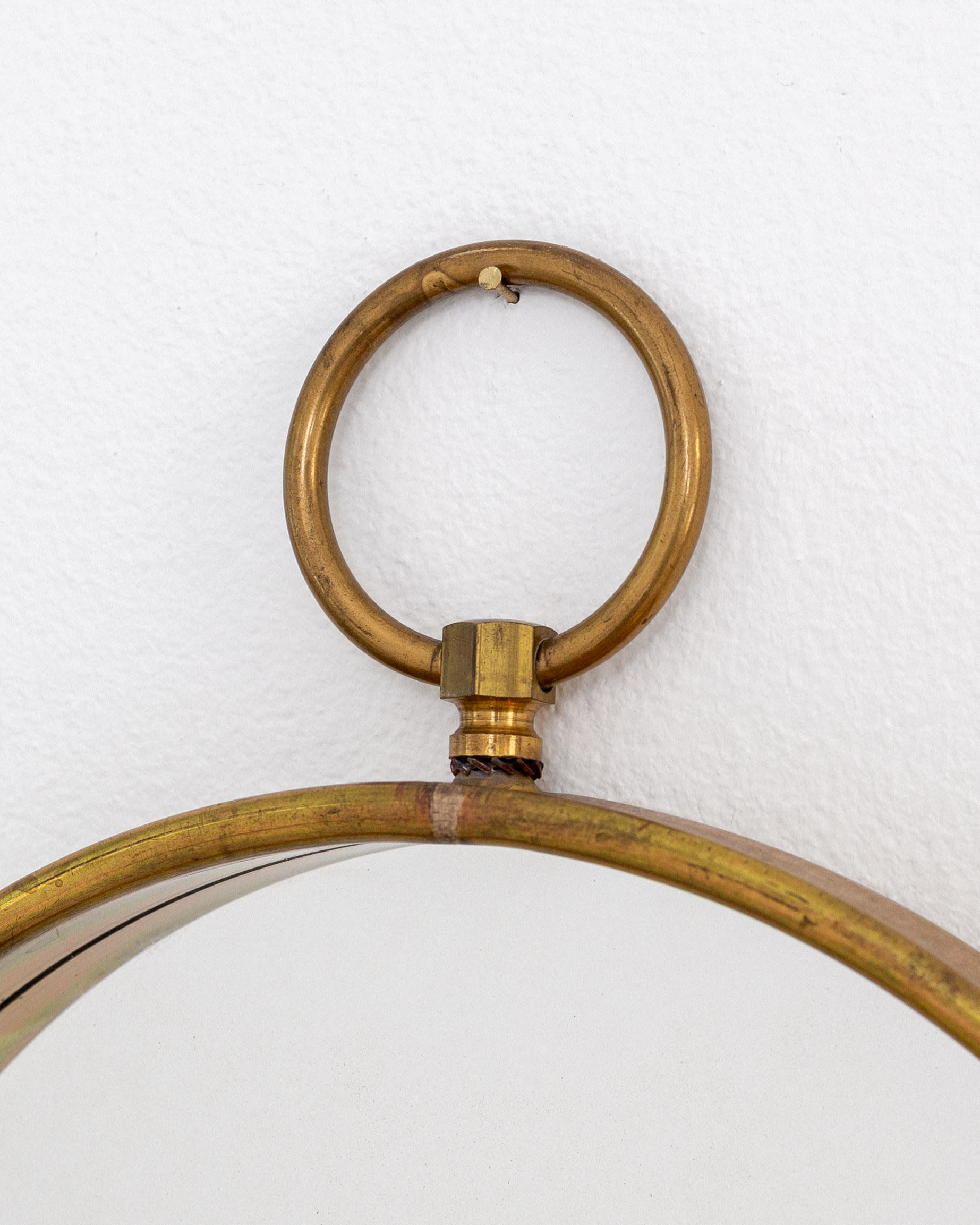 Scandinavian Mid-Century Round Brass Mirror — top view of brass ring detail