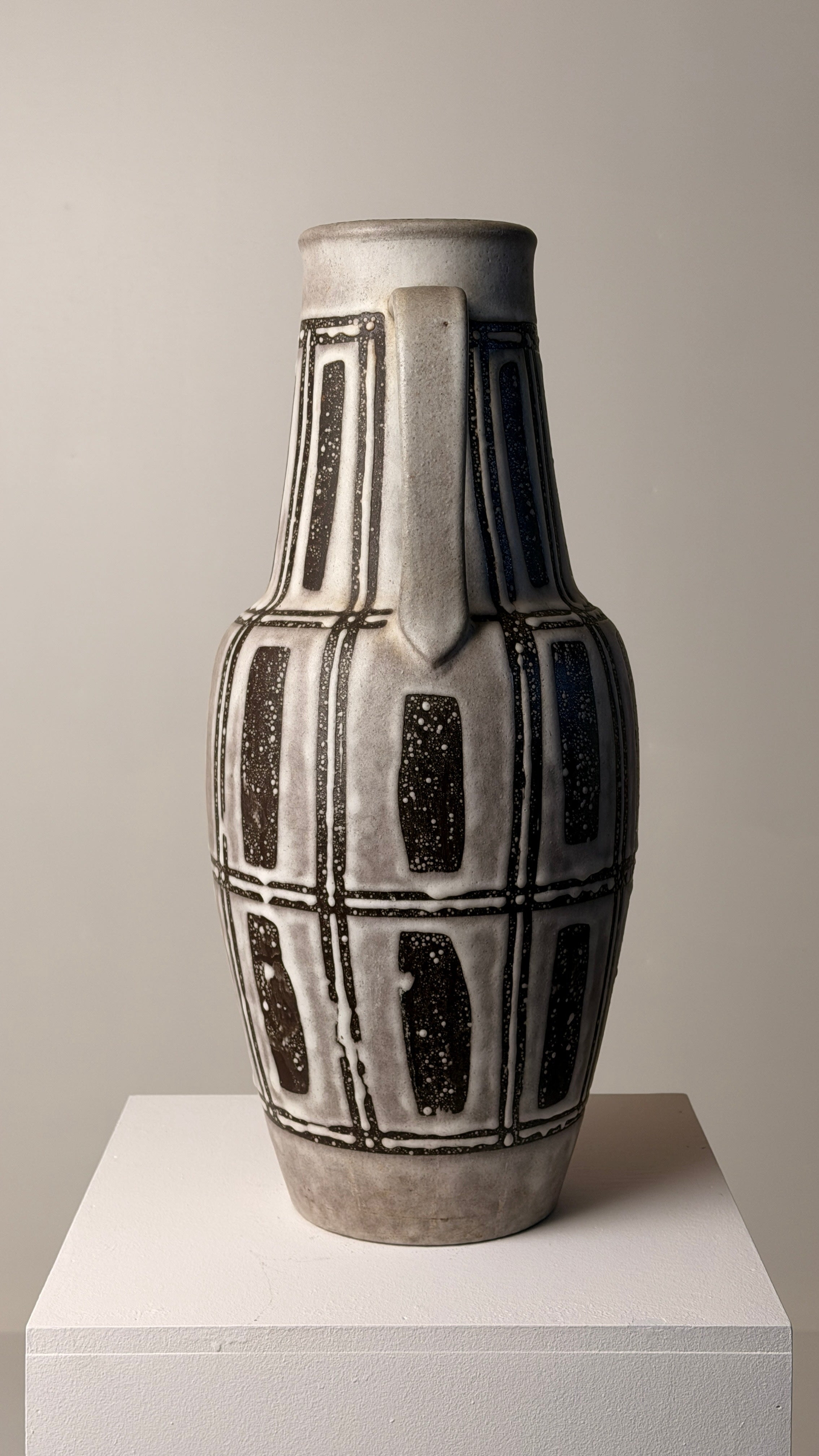 Ceramic pitcher, Germany, circa 1960 — side view on white pedestal