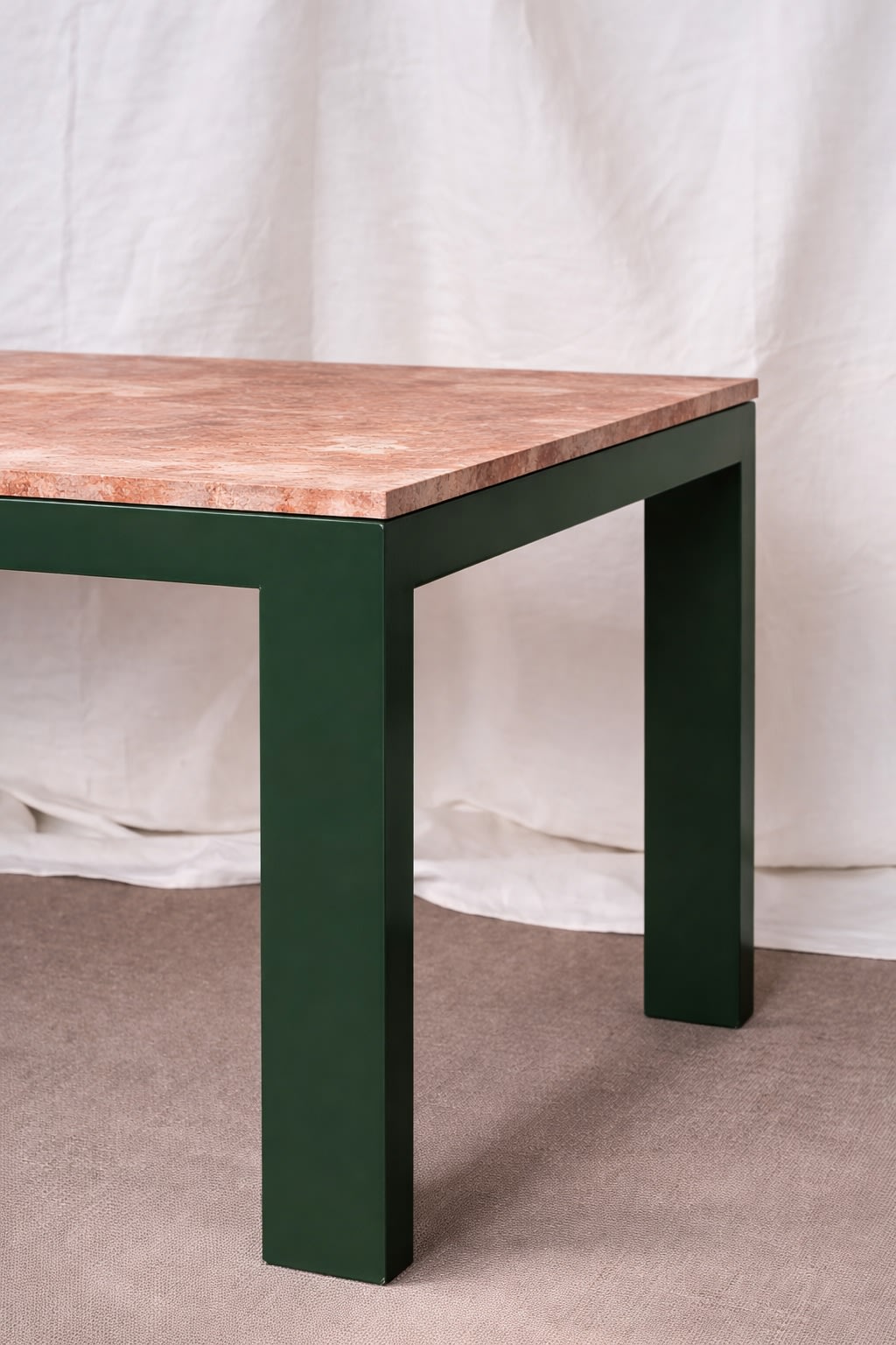 Firme Dining Table — angled view of green legs and textured top
