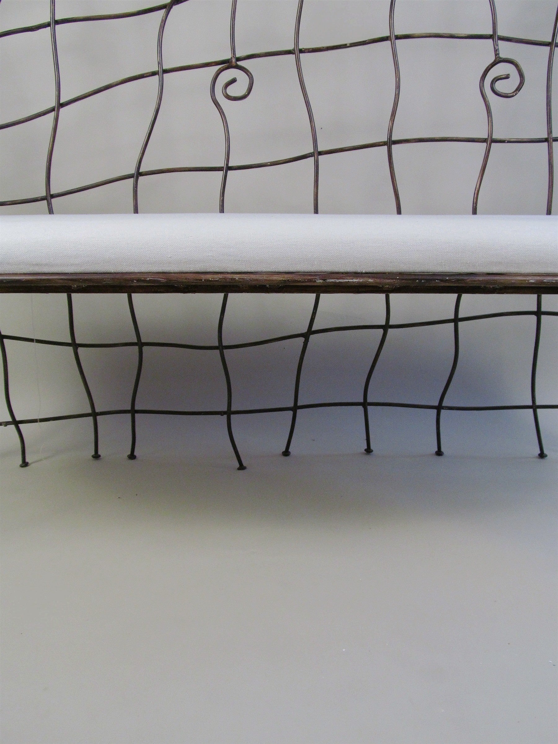 Scrollwork Iron Bench — front view of iron frame with cushion
