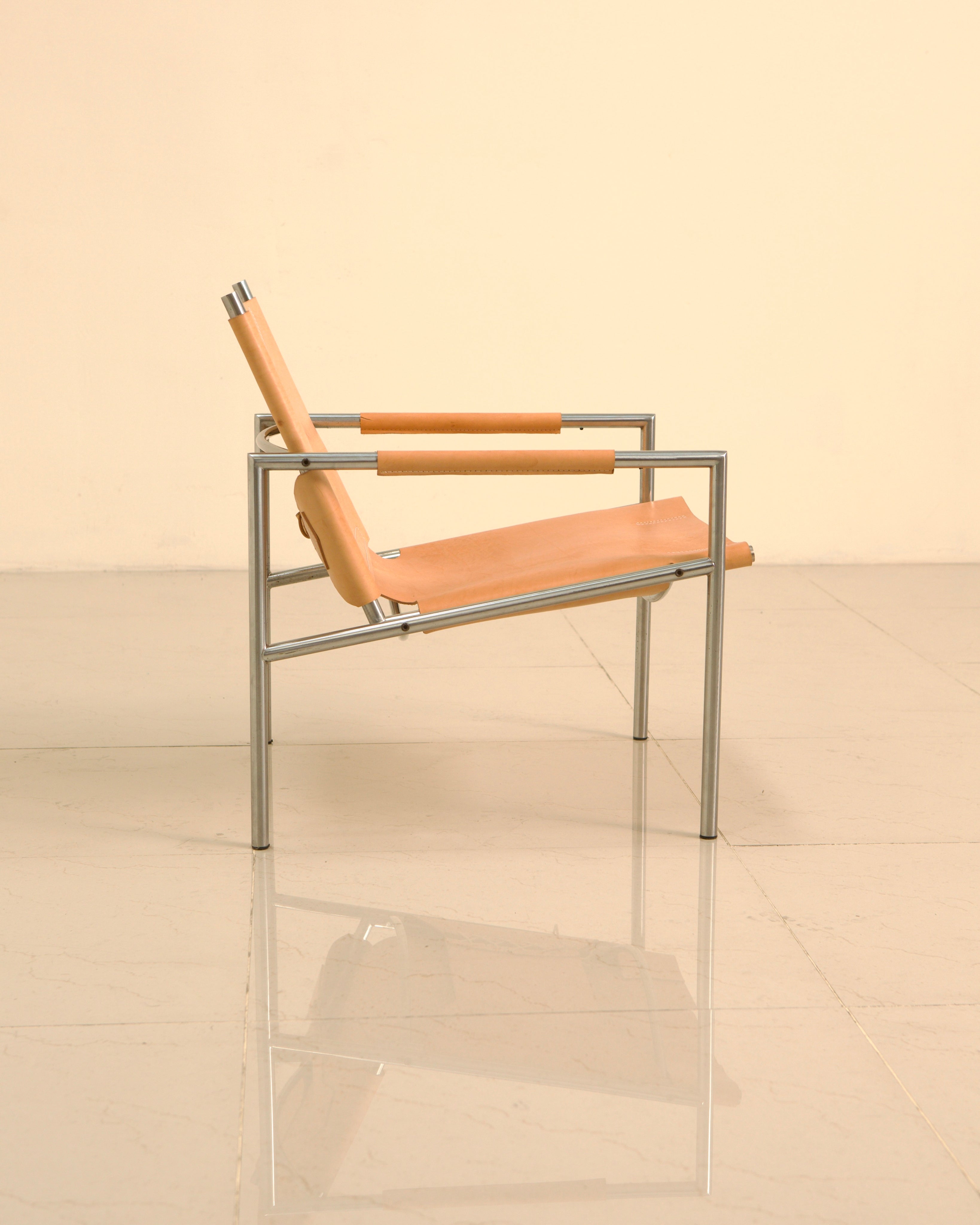 SZ02 armchair profile view showing tan leather sling seat design