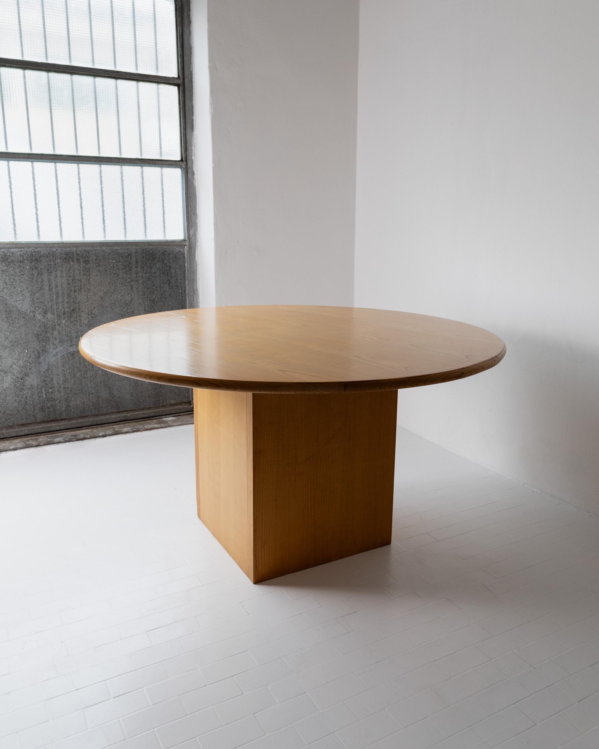 1980s Large Round Wooden Table — angled view in minimalist interior