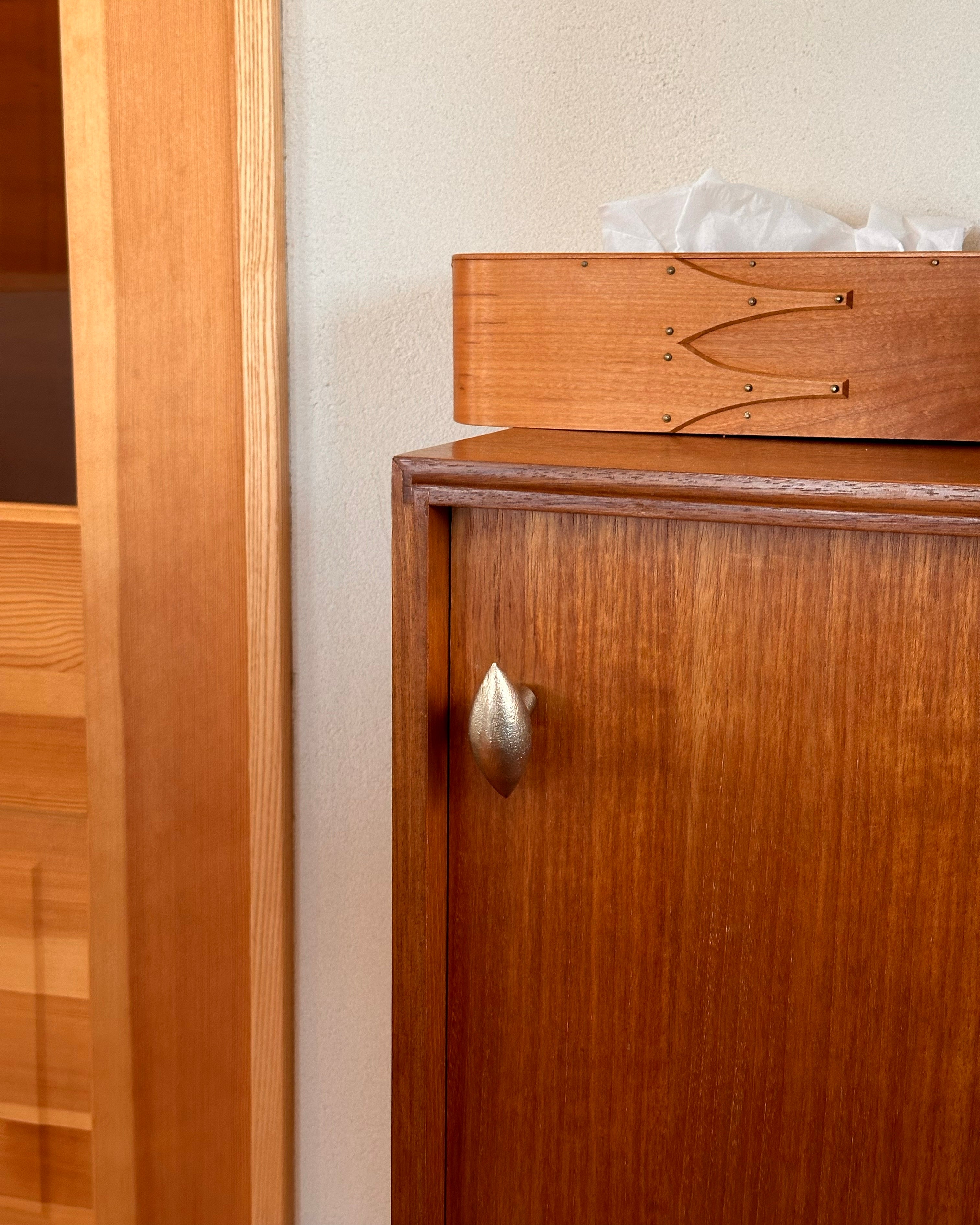 GOOD EYE Cabinet Knob/Wall Hook — close-up of brass knob on wooden cabinet