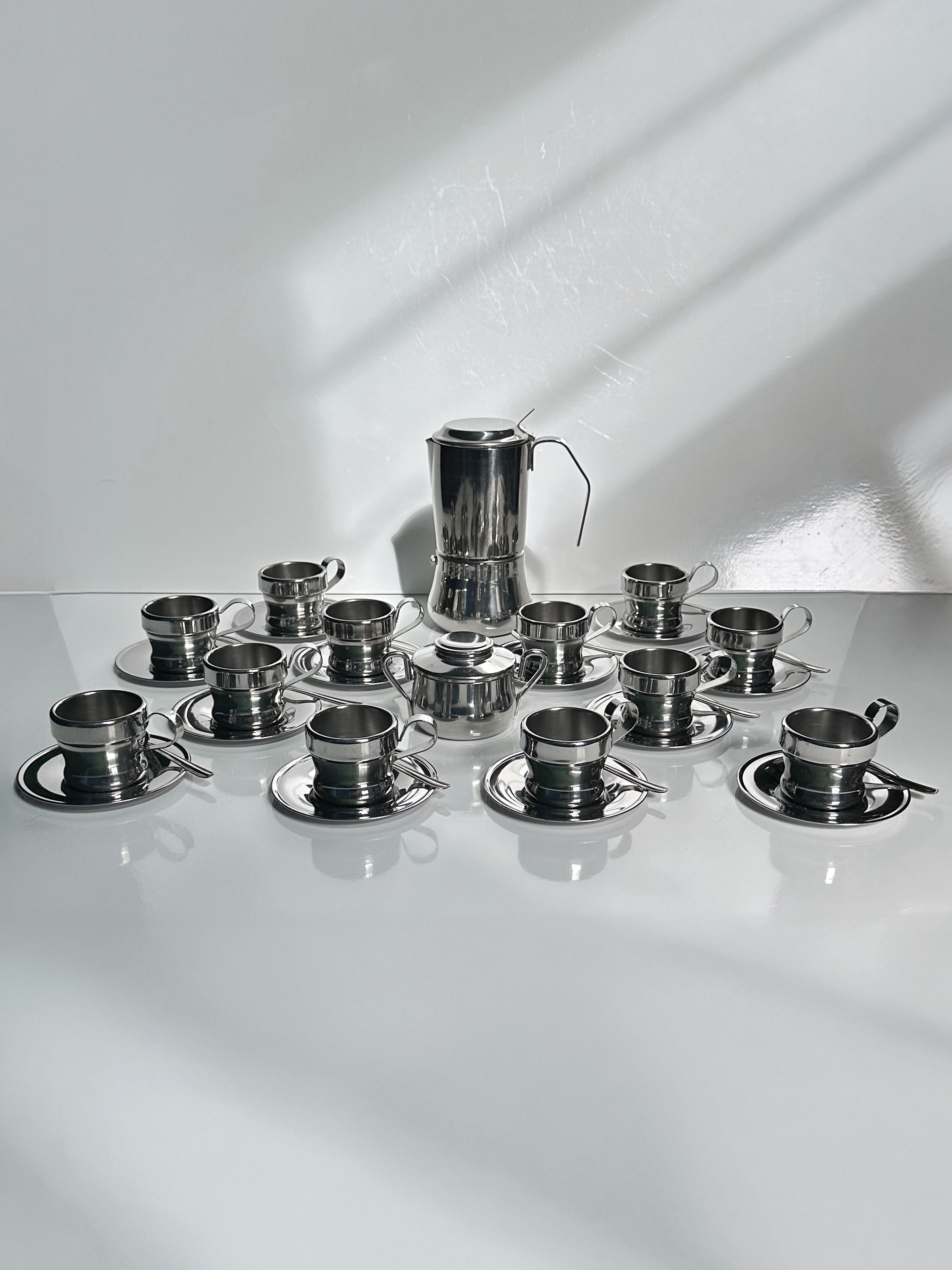 Italian Stainless Steel Coffee Set for 12 Persons — arranged on white surface with shadows