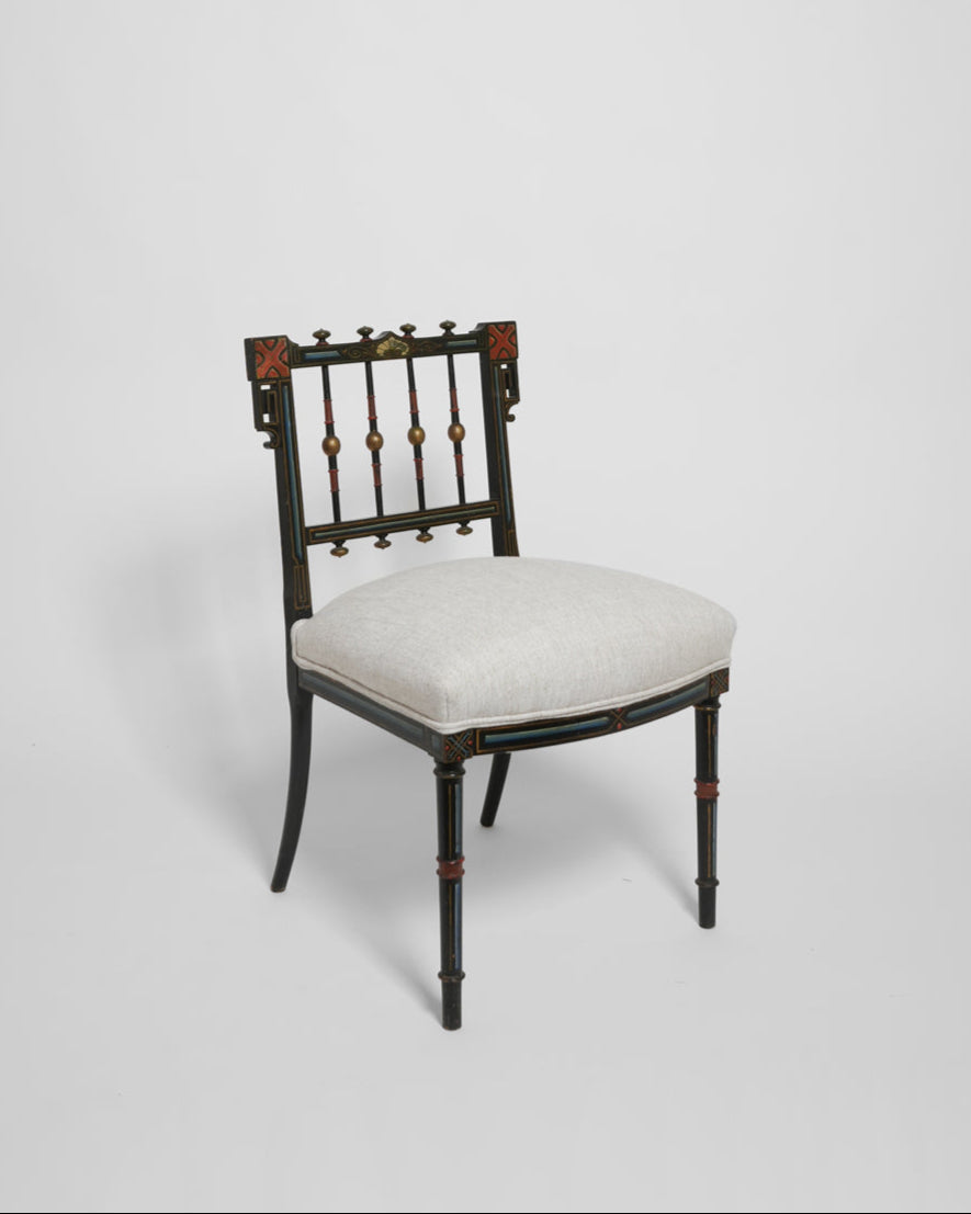 The Napoleon III Painted Armchair by Barracuda Interiors, 19th c., features black and red accents, an upholstered light beige seat, and a slatted backrest, shown against a plain white background.