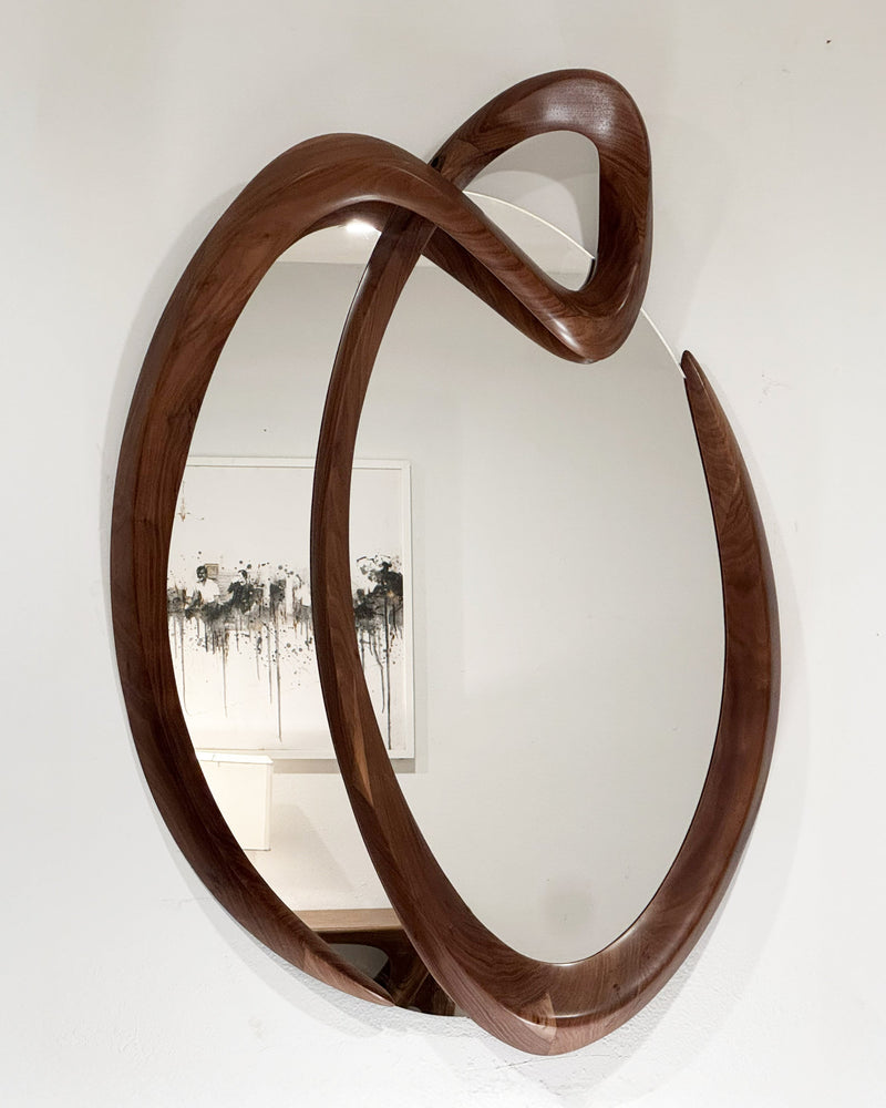 Saba Wall Mirror in Natural Stain on Walnut Wood — close-up of curved walnut frame