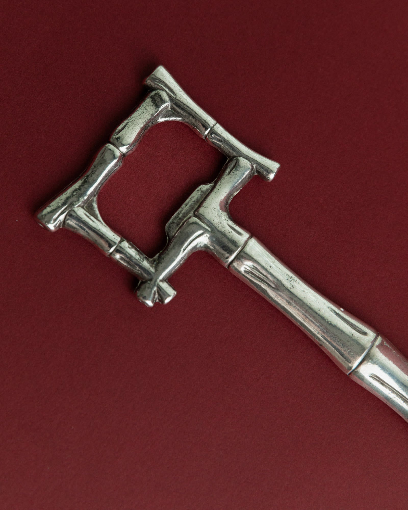Vintage 1970s Silver Plated Bottle Opener, Bamboo Design — close-up of textured silver surface
