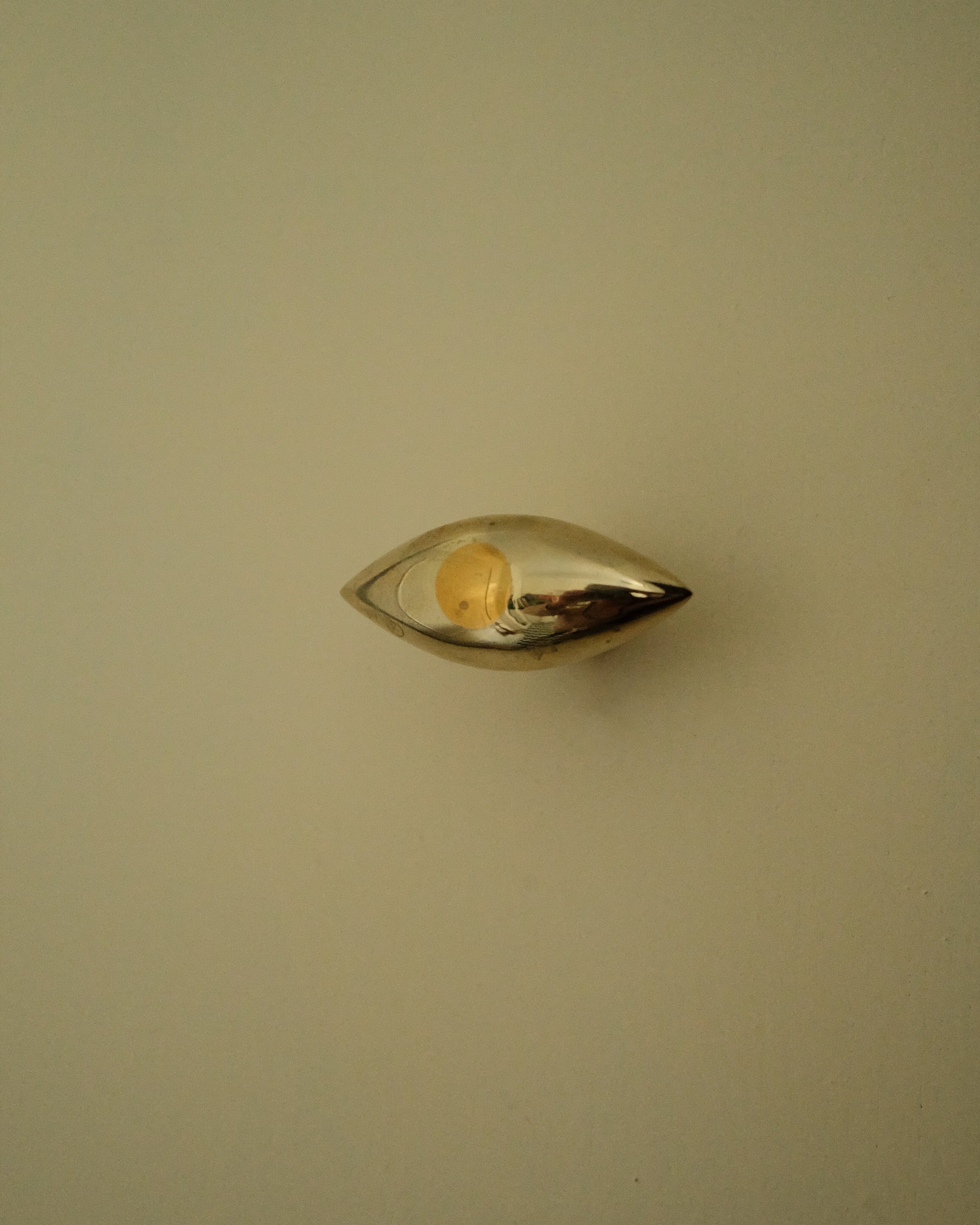 GOOD EYE Cabinet Knob/Wall Hook — top view of polished metal design