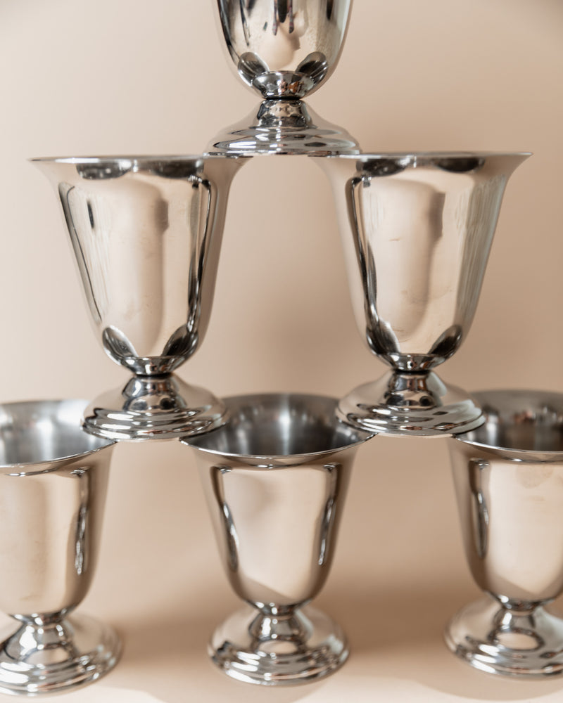 Stacked stainless steel cups pyramid formation Italian design