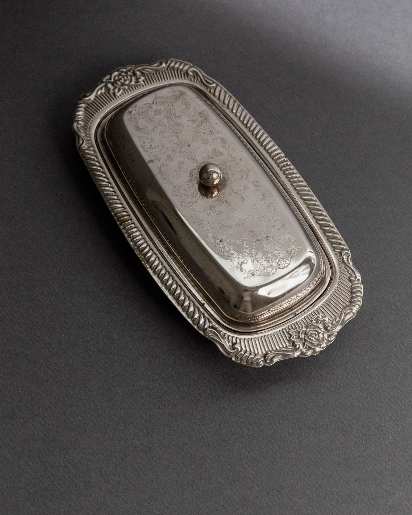Previous slide Next slide Vintage 1970s Silver Plated Butter Dish, Engraved Ornamental — angled view highlighting ornate lid