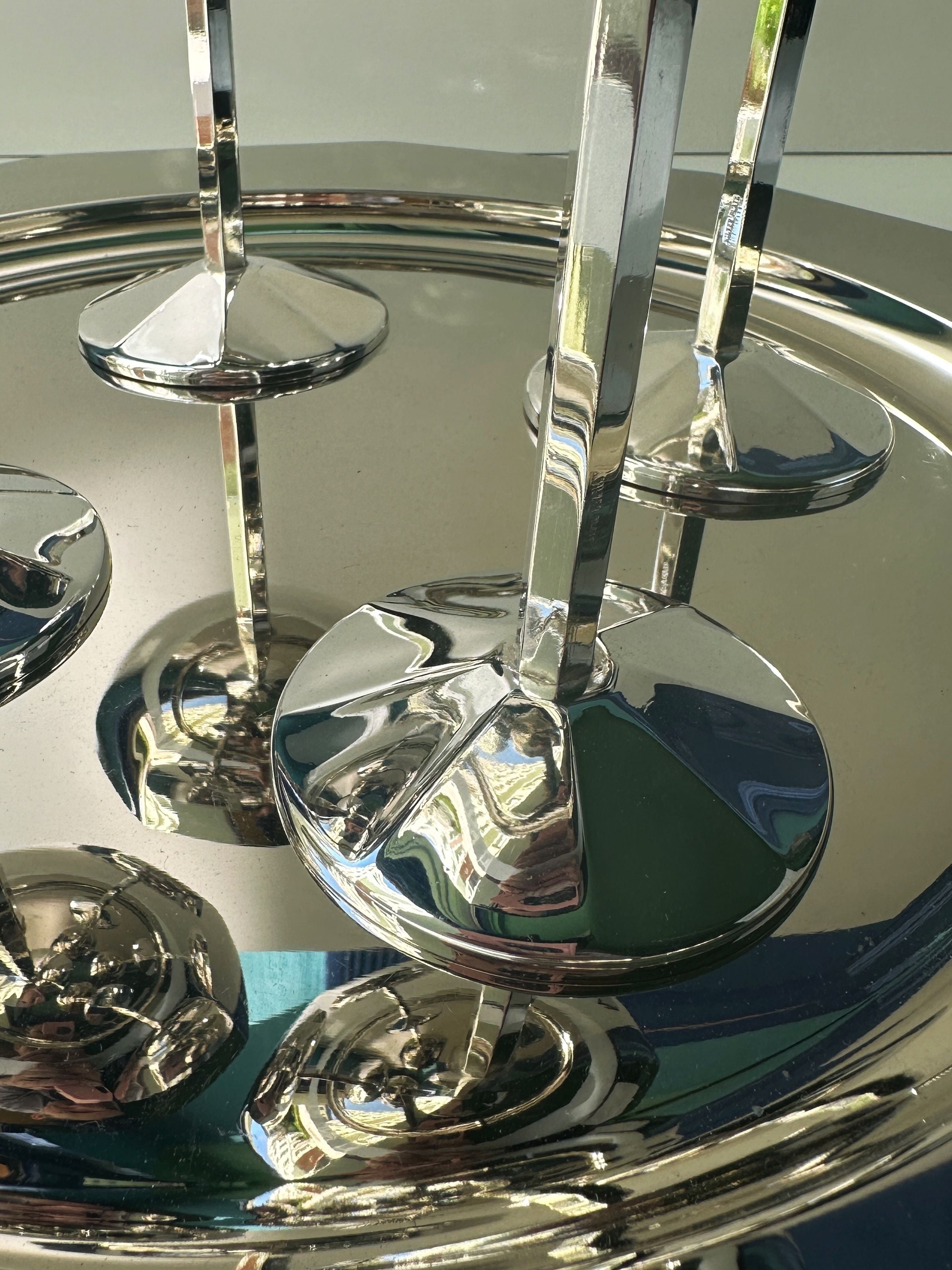 Reflective silver-plated champagne coupes showing mirror finish detail