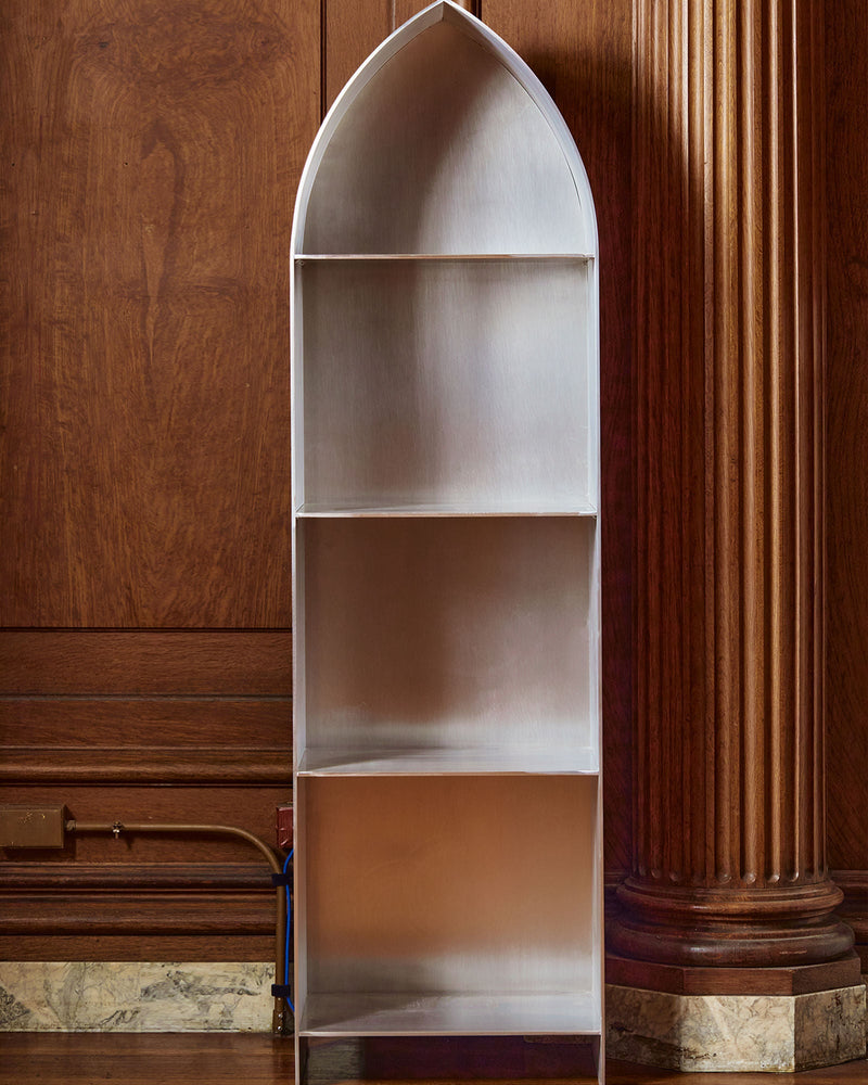 White arched bookcase with three shelves in elegant interior
