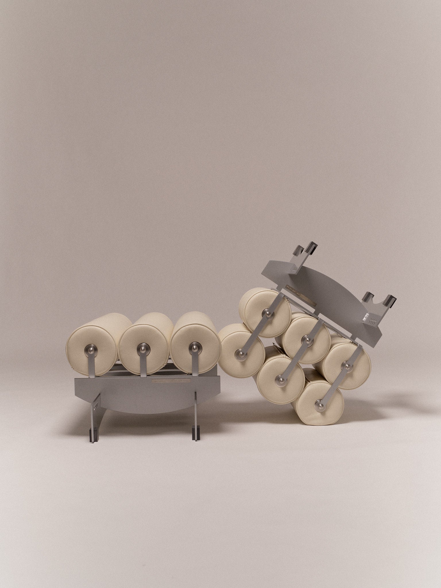 Ottoman Bassa — angled view of gray frame with cream cushions