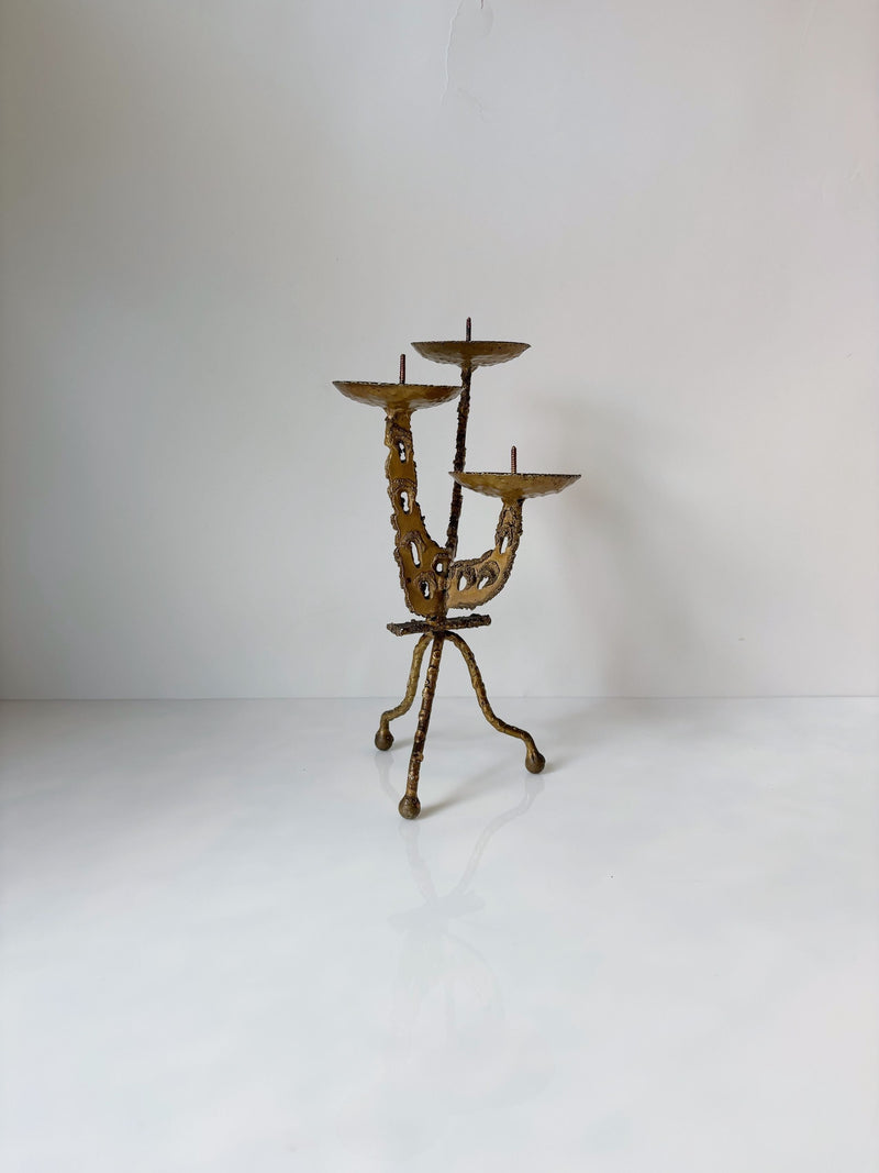 Brutalist torched metal three-arm candleholder on tripod base