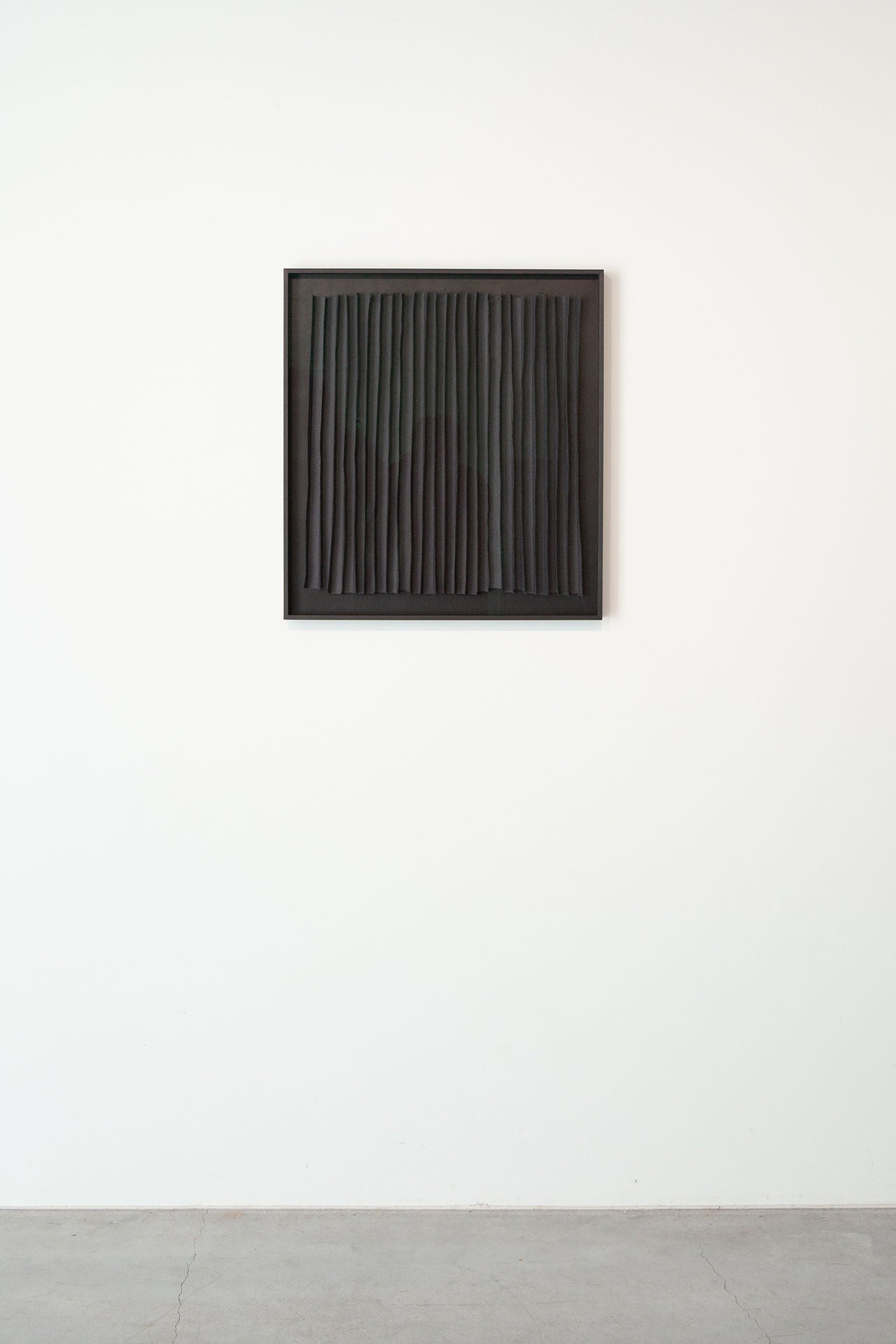 Vertical black paper strips creating rhythmic pattern composition