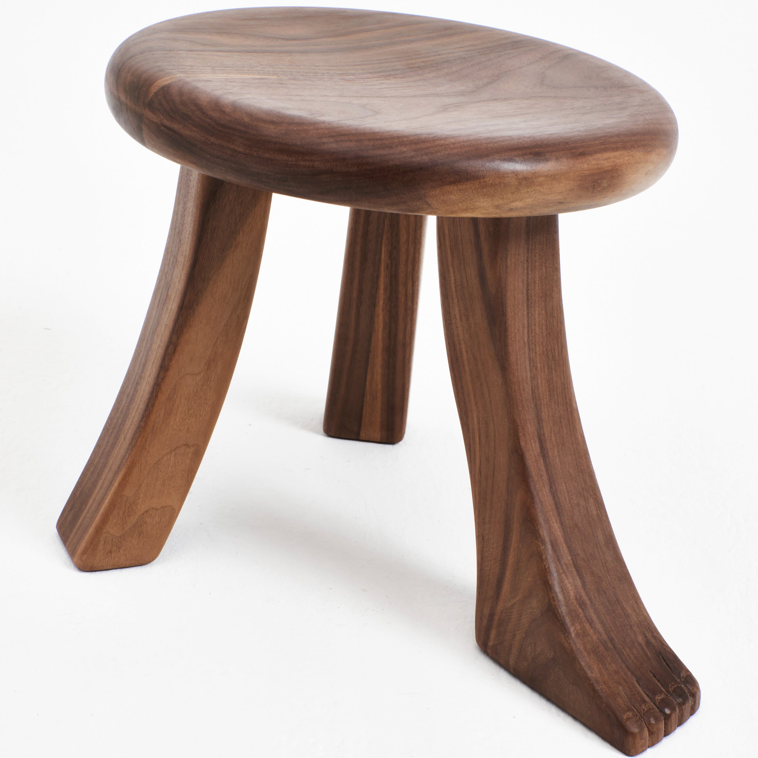 Foot Stool in Oak — angled view highlighting curved wooden legs