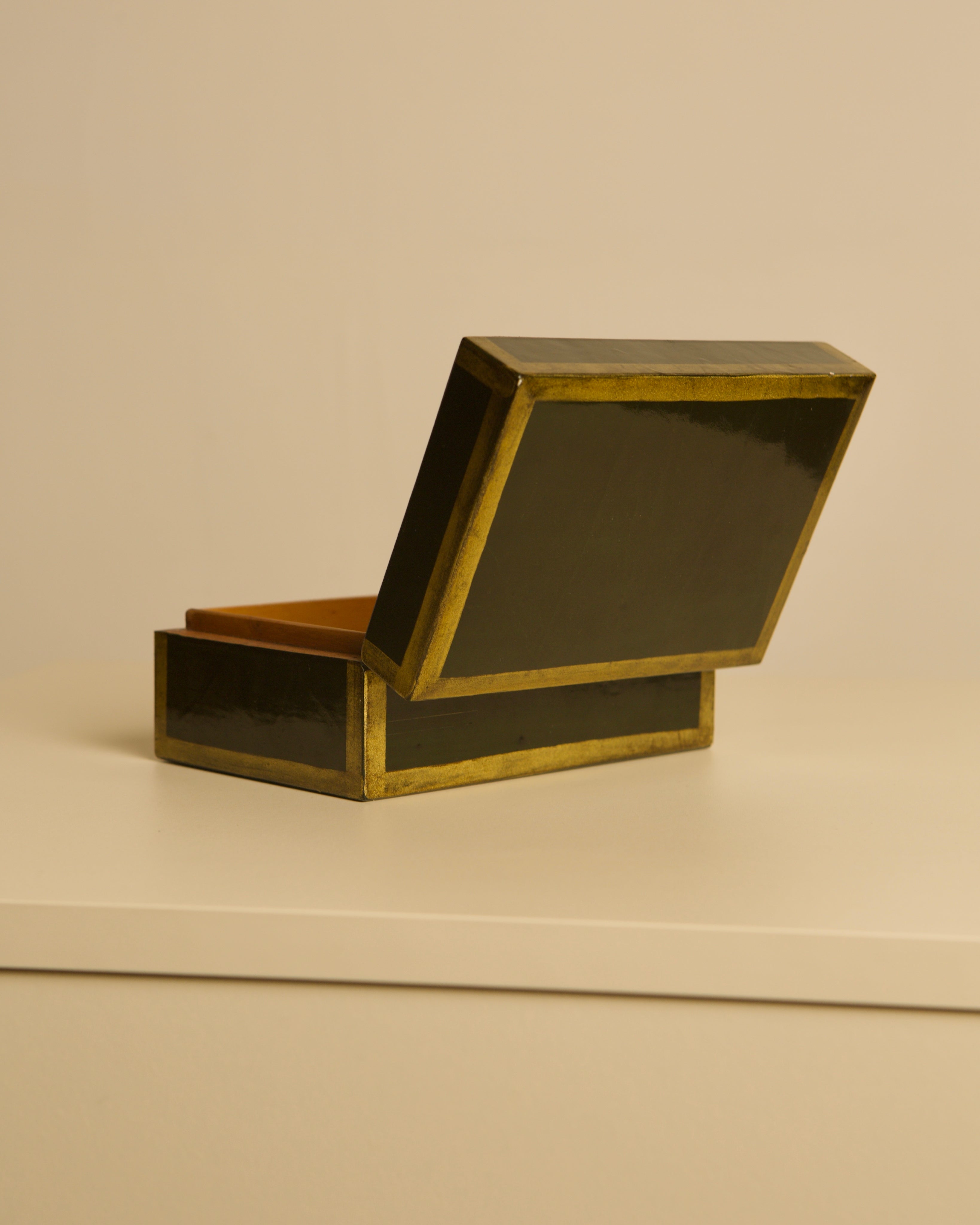 Italian box in Forest Green Lacquered Wood, 80s — angled view with open lid on white surface