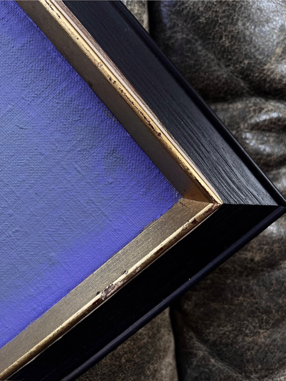 Color Studies: Mauve no.I — corner view of framed painting on leather couch