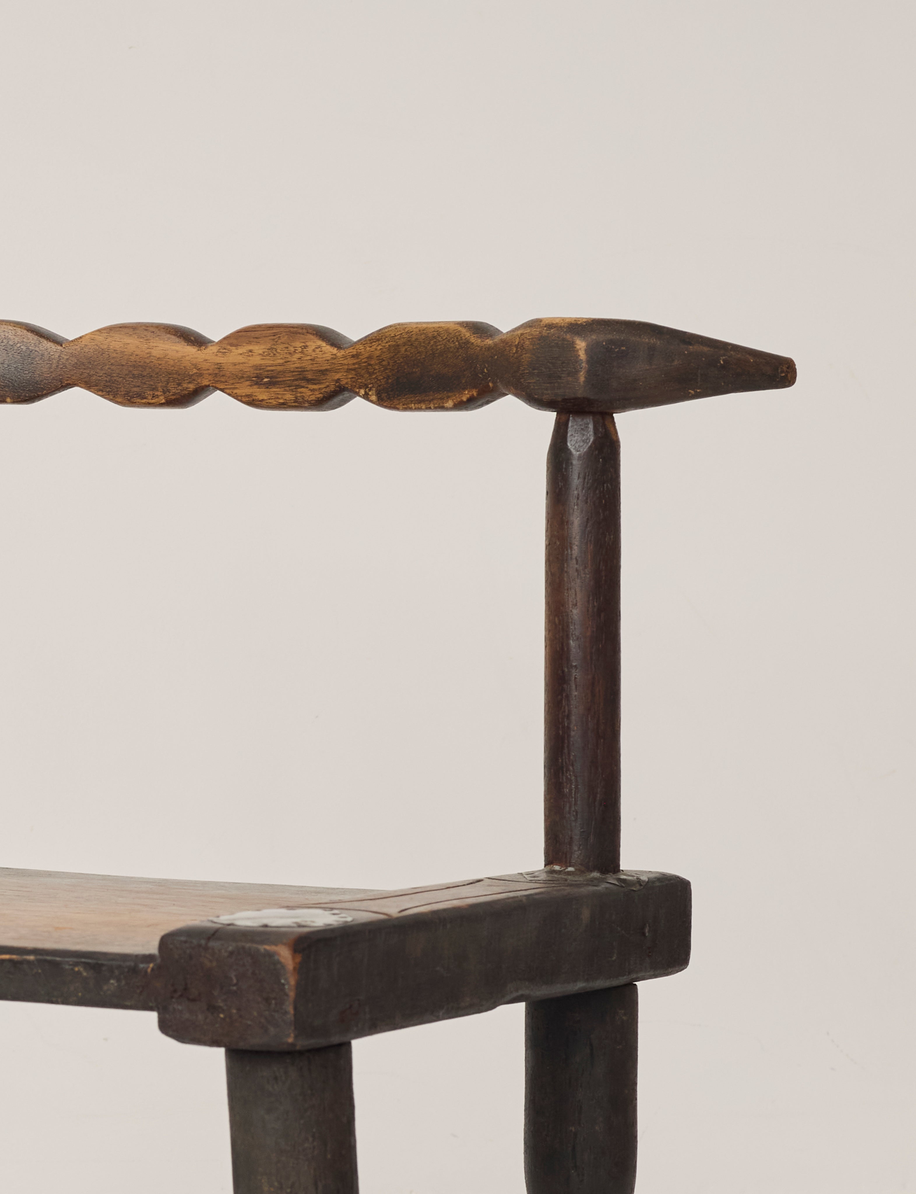 Small artisanal vintage West African chair "Baoulé" in solid wood C. 1960 — lifestyle setting