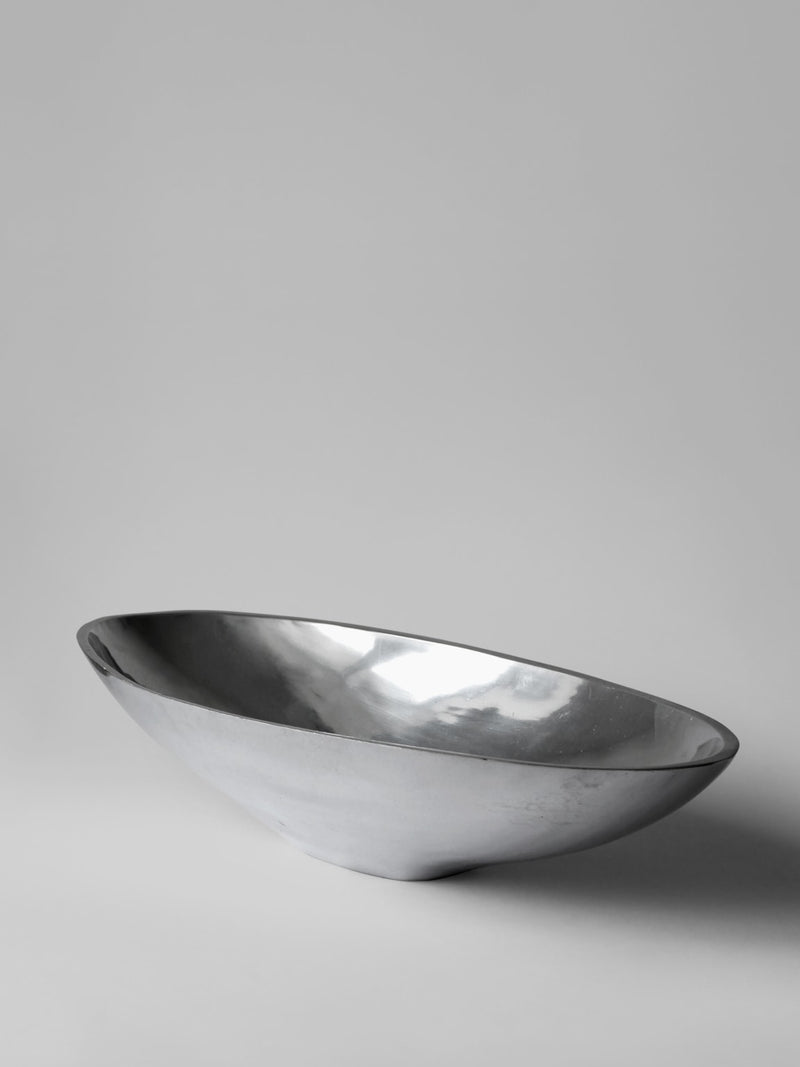 Polished aluminum bowl side profile showing curved contemporary design
