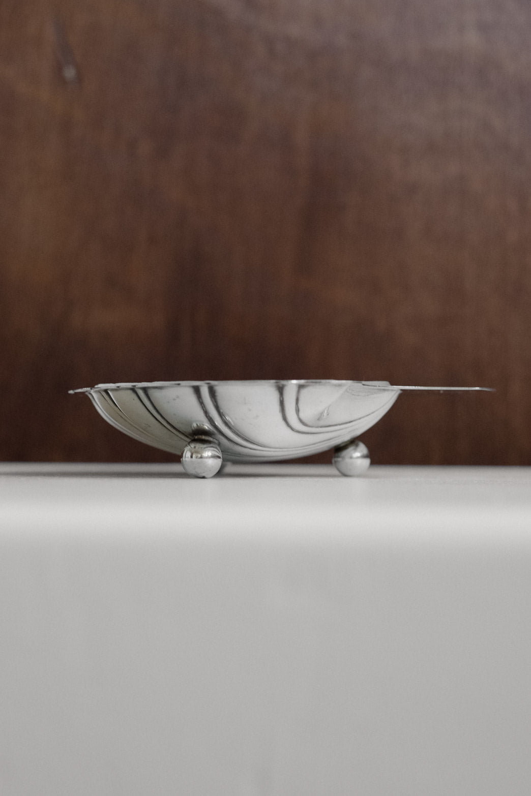 Shell Shaped Butter Dish — side view highlighting polished silver finish