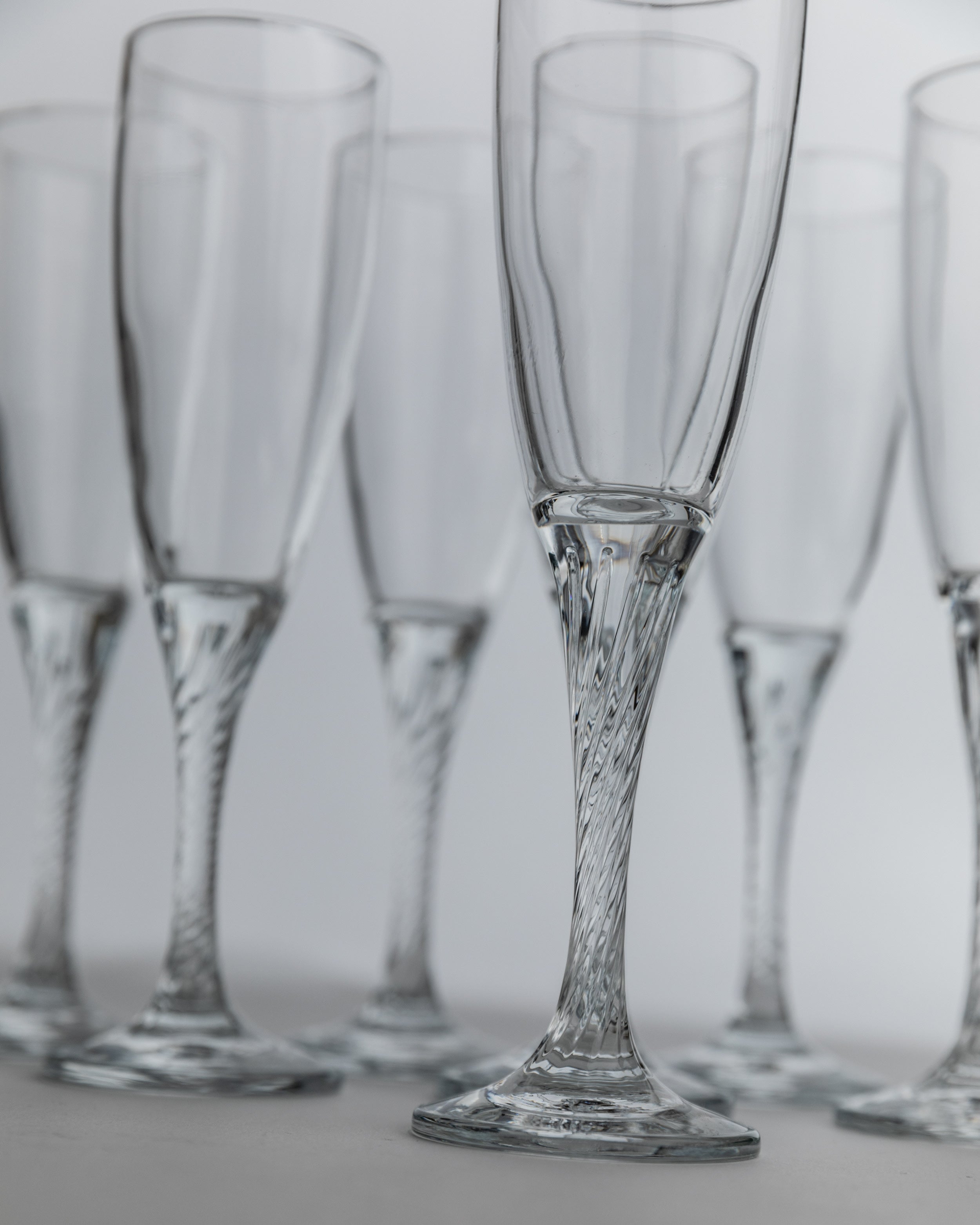 Elegant crystal champagne flutes with twisted stems detail view