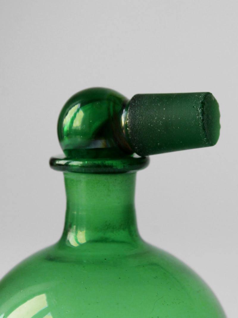 Emerald green glass perfume bottle stopper and neck detail