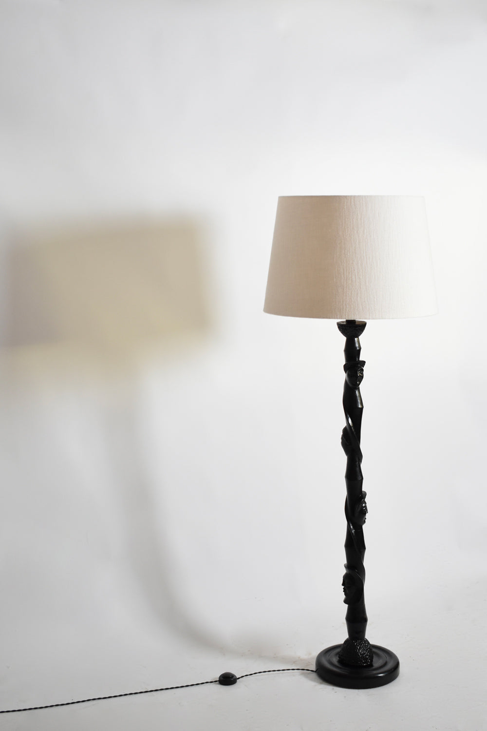 Africanist ebonised wood floor lamp, 1970s — side angle