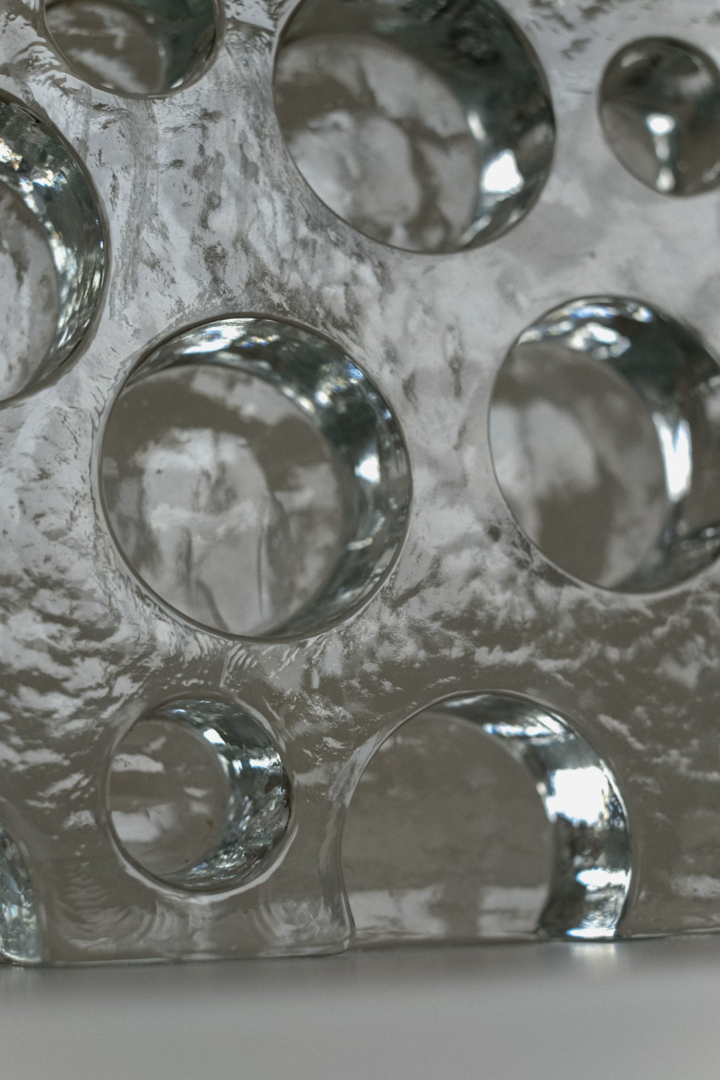 Glass Candle Holder — close-up of textured glass surface with circular cutouts