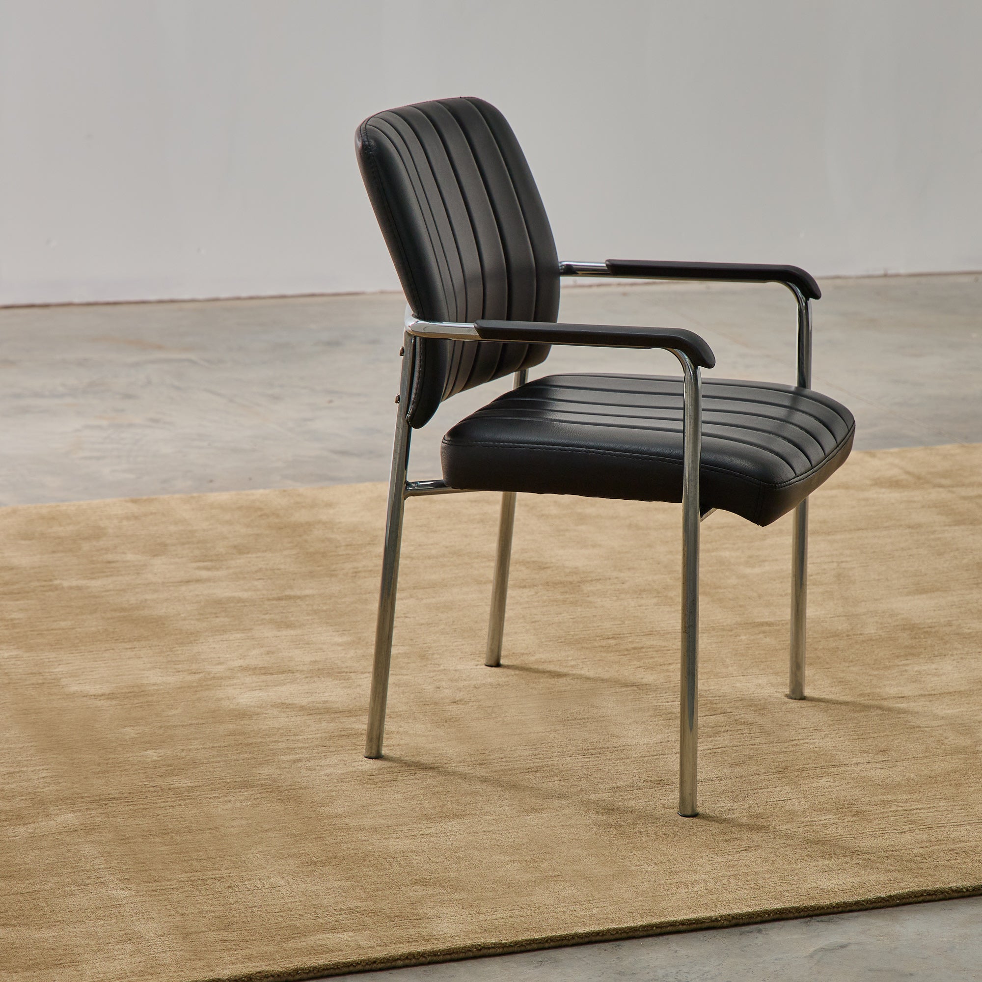 Hand-woven Rug in New Zealand Wool, Châtaigne — rug under modern chair in minimalist setting