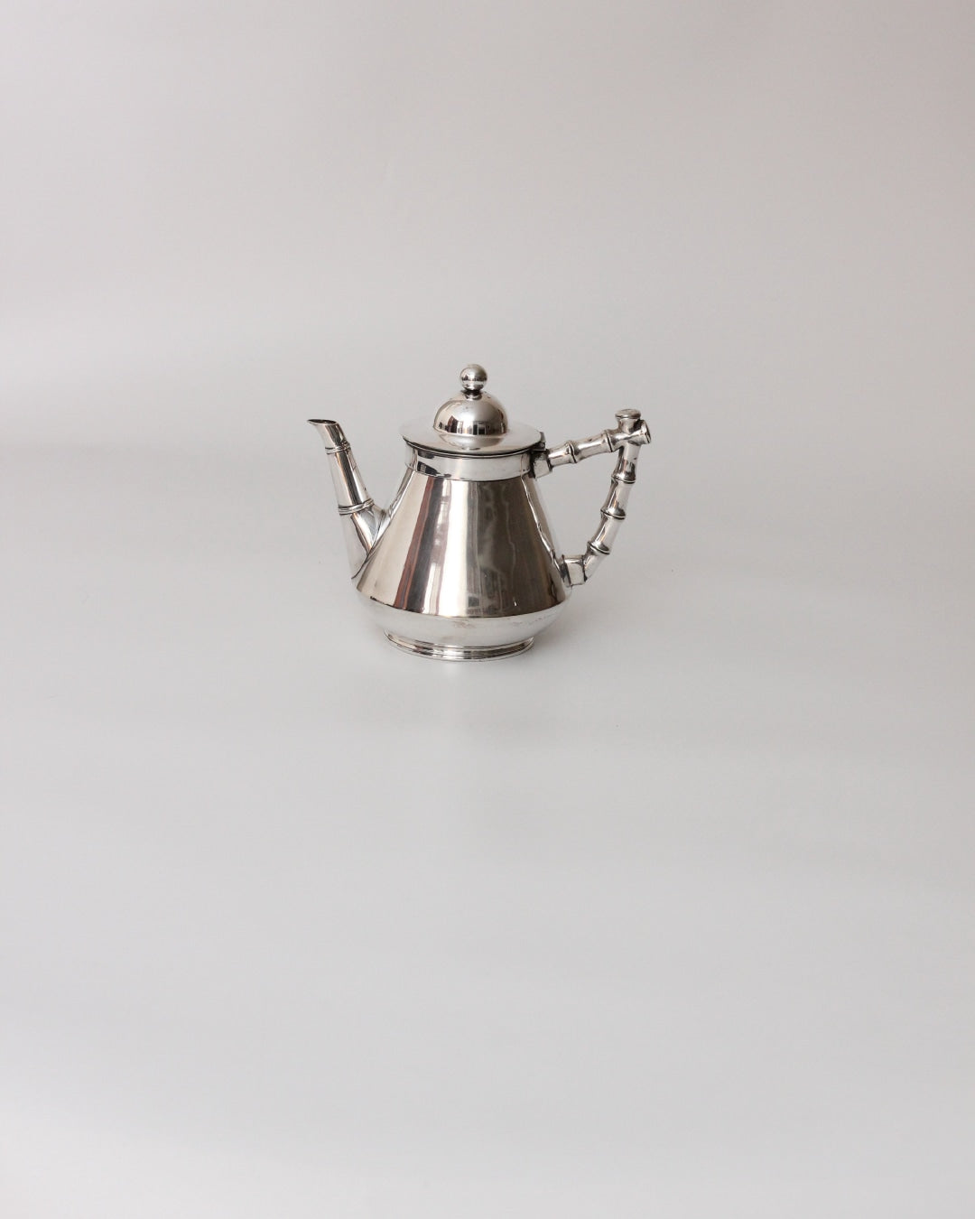 Art Deco Coffee Set — angled view of polished silver teapot